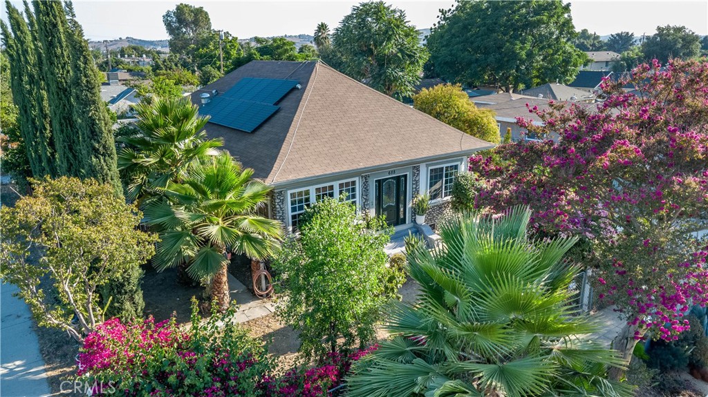 Attention Agents, In-Home Income Seekers, Investors, Flippers, Builders and Land Lovers! Potentially divisible lot! Rare opportunity in Pomona! This oversized 16,156 sq ft flat corner lot (approx. 0.37 acre) offers exceptional potential for development, expansion, or multigenerational living. With a side-by-side lot orientation, it’s ideal for a future split into two independent homes—unlike a typical flag lot configuration. Perfect for investors or those who simply want to move into a quiet, tree-lined neighborhood, this property is also great for in-home income seekers—those who live in one part and rent out the other. The home is move-in ready, featuring three generously sized bedrooms, 1 full bathroom, 2 three-quarter bathrooms, and a versatile bonus room perfect for a home office, guest room, or creative studio. Per seller, the home has been rewired and re-piped (buyer to verify). A solar system installed in 2022 (buyer to assume lease) keeps utility costs low. A long driveway, detached garage, and massive backyard and side yard provide space, privacy, and flexibility. And don't forget the backyard bonus - a mini farm orchard with grapefruit, dragon fruit, orange, peach, and jujube trees. This is a must-see property—photos can’t capture the spacious feel or the potential of the land. Act fast - opportunities like this don't last!