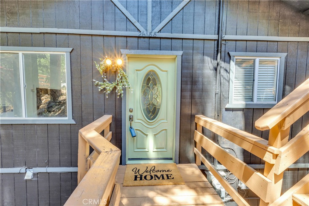 This charming cabin blends rustic character with some great modern touches. When you arrive, you’ll find a spacious 2-car parking deck that makes coming and going a breeze. Head down the stairs, on the right, and you’ll reach the front entrance of a well-kept, thoughtfully updated home with a working gas fireplace that adds a cozy touch.
Inside, the cabin has a fresh feel with newly painted walls, doors, and cabinets, along with a clean, modern exterior paint job. The kitchen has had some nice updates over the years—new lighting, refinished countertops (done about 10 years ago), and fully remodeled bathrooms that still feel current. The open living space leads out to a generous deck—plenty of room for outdoor dining or just relaxing in the trees.
The home features two bedrooms and two bathrooms, each with its own walk-in shower, making it a great setup for guests or sharing. The surrounding mature trees offer privacy and a peaceful setting—it really feels like your own little retreat in the woods.