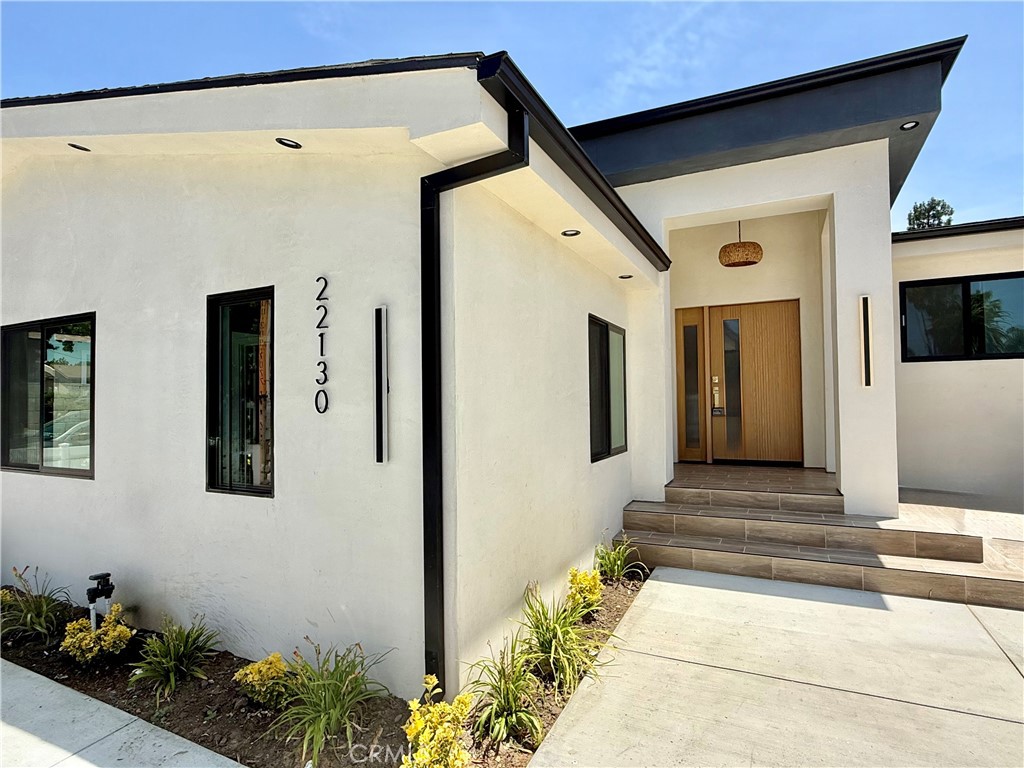 Modern elegance meets thoughtful design in this brand-new 3-bedroom, 3-bathroom home, built to offer style, comfort, and functionality at every turn. Step inside to soaring 10-foot ceilings, gold-accented finishes, and an airy open layout that feels instantly inviting. The heart of the home is the chef-inspired kitchen, showcasing a massive island with generous cabinetry, custom woodwork, and premium stainless steel appliances—including a 5-burner stove, oven, refrigerator, dishwasher, and deep sink—all enhanced by pendant lighting and a stylish tile backsplash.
Just off the entry, a spacious laundry room provides floor-to-ceiling cabinetry designed to accommodate a stackable washer and dryer. A chic powder room with bold gold fixtures adds a touch of luxury. Two of the bedrooms offer mirrored closet doors, while the expansive primary suite includes a huge walk-in closet and a beautifully appointed bathroom with dual sinks, a large walk-in shower, and a built-in bench for added comfort. An additional hallway bathroom also features double vanities and a sleek shower, perfect for guests or shared living.
The bright living room opens seamlessly to a private backyard oasis—ideal for relaxing or entertaining. At the back of the yard sits a charming, detached storage unit that’s perfect for tools, seasonal storage, or can easily be repurposed as a hobby space, crafts room, or serene studio. You’ll also enjoy the convenience of two dedicated parking spots, central heating and air, high-end finishes throughout, and custom cabinetry in every room. With everything brand new and thoughtfully designed, this home is ready to support your next chapter in style and comfort.