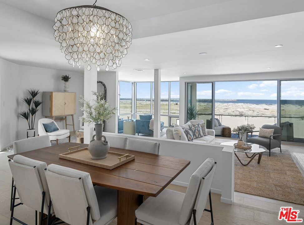 A rare opportunity to own a stunning oceanfront home in one of Marina del Rey's most coveted beachfront buildings. Experience the ultimate in coastal luxury in this sun-drenched, newly renovated 2-bedroom, 2.5-bath south corner unit. Perfectly positioned on a prime stretch of sand, this exceptional residence offers sweeping, unobstructed ocean views from nearly every room. Thoughtfully reimagined with a modern aesthetic, the open-concept floor plan is bathed in natural light through expansive floor-to-ceiling windows and sliding glass doors that frame breathtaking vistas of the Pacific. Rich hardwood floors flow through the main living areas, which include a stylish living room with fireplace, a dedicated dining area, and a chef's kitchen. The brand new kitchen is equipped with top-of-the-line stainless steel appliances, custom cabinetry, sleek porcelain countertops, and an oversized island perfect for cooking, casual dining and entertaining. The spacious primary suite is a tranquil retreat, featuring its own fireplace, cozy sitting area, and generous closet space. A spa-inspired primary bath includes dual vanities, a soaking tub, and a large walk-in shower. The second bedroom is well-proportioned and includes its own beautifully appointed full bath, ideal for a kid's room, guest space, or home office. Additional highlights include a chic powder room, a separate laundry room, and a private balcony ideal for sunset-watching and ocean breezes. Situated just moments from world-class dining, shopping, and the vibrant Marina lifestyle, this rare offering combines sophisticated design, breathtaking views, and an unbeatable beachfront location.