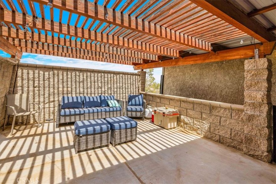 This exceptional 3-bedroom, 2.5-bathroom residence is nestled on a spacious half-acre lot in the desirable Mesa area of Yucca Valley. Conveniently located off paved Caliente St, this property offers both privacy and functionality, with thoughtful features and upgrades throughout.

As you approach, you'll notice the fully fenced property, complete with a detached, fully finished garage, a sizeable storage shed, and a sunken walipini-style greenhouse—perfect for gardening enthusiasts. Majestic pines provide shade and add to the serene ambiance of the grounds.

The entrance features a charming courtyard, fully enclosed with high block walls for privacy, wind protection, and shaded for comfort—a true outdoor retreat. Step inside to discover a spacious open-concept living area, boasting newer dual-pane windows, LED lighting, and a cozy wood stove set on a striking rustic limestone hearth. The adjoining dining area flows seamlessly into the updated kitchen, which impresses with its sleek granite countertops, stainless steel appliances, and abundant warm wooden cabinetry. A side door offers convenient access to the side yard with RV parking.

The guest bathroom is beautifully finished with a tiled tub/shower combo and tiled countertops. Two guest bedrooms provide plenty of comfort; one features a large closet, while the other offers a walk-in closet and an attached private half bath.

The large primary suite is a haven of relaxation, with its own private sliding door to the courtyard, a large walk-in closet, and a luxurious master bathroom with a fully tiled walk-in shower and tiled countertops. The home is equipped with a large laundry and utility room, providing extra storage and backyard access. Climate control includes a new HVAC unit to ensure year-round comfort.

This home offers the perfect combination of rural tranquility and modern convenience. Don’t miss your chance to own this unique gem in Yucca Valley! Schedule a showing today! ???