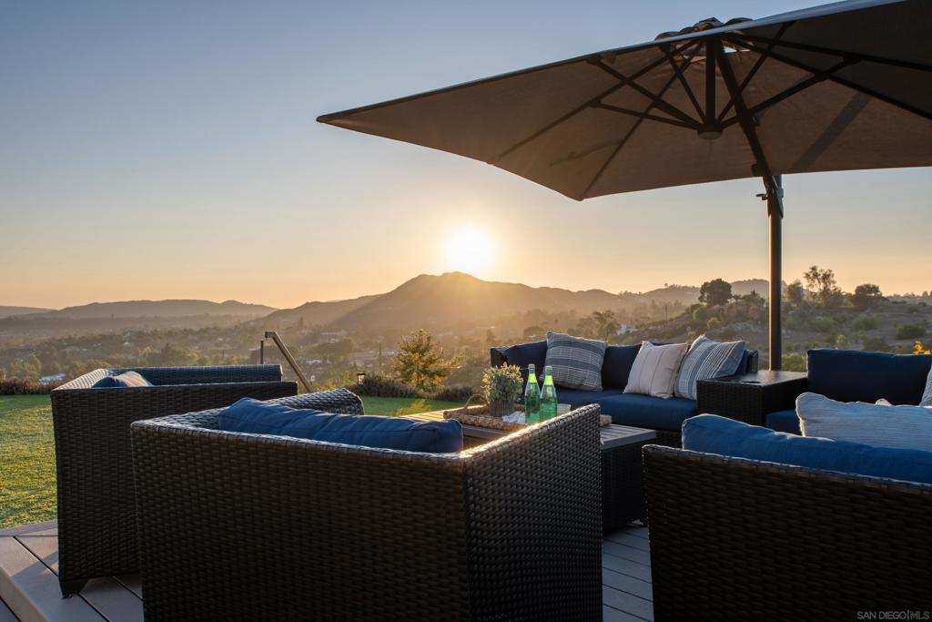 The High Valley lifestyle is one the best kept-secrets in San Diego! Tucked away in the scenic hills of Poway, California, an easy commute to the heart of San Diego. With a 2-acre minimum, High Valley offers a rare blend of privacy, serenity, and peace. A design-forward beauty poised atop a premier parcel. Epic entertaining opportunities await with two outdoor kitchens, entertainment lounge and a poolside backdrop for unforgettable gatherings. Southern California living at its best with sweeping valley and mountain vistas! Expansive turf lawns for unlimited fun and activity, polish your golf game on the putting green, and work that perfect swing in the custom batting cage and driving range. If you can dream it, you live it. Step inside to discover an open-concept layout, an entry-level primary suite, a chef-caliber kitchen with top-tier appliances, and expansive living spaces. A dedicated study area and oversized loft offer flexibility for work or play. Energy-efficient features include owned solar, a TESLA electric car charger, LED recessed lighting, dual tankless water heaters with on-demand pumps, radiant roof barriers, two-zone HVAC with programmable thermostats, and low-VOC paint. Newly painted inside and out in 2024. Enhancements include a solar-heated, saltwater pool and spa, elevated view deck, putting green, fitness zone, two BBQ areas, artificial turf, batting cage, outdoor shower, and multiple lounging areas, all curated to create an entertainer’s dream or private retreat. This extraordinary property is also located within the boundaries of Poway’s award-winning schools. The long private driveway ensures plenty of parking and privacy, seamlessly blending sophistication, innovation, and lifestyle, this is Southern California living at its finest.