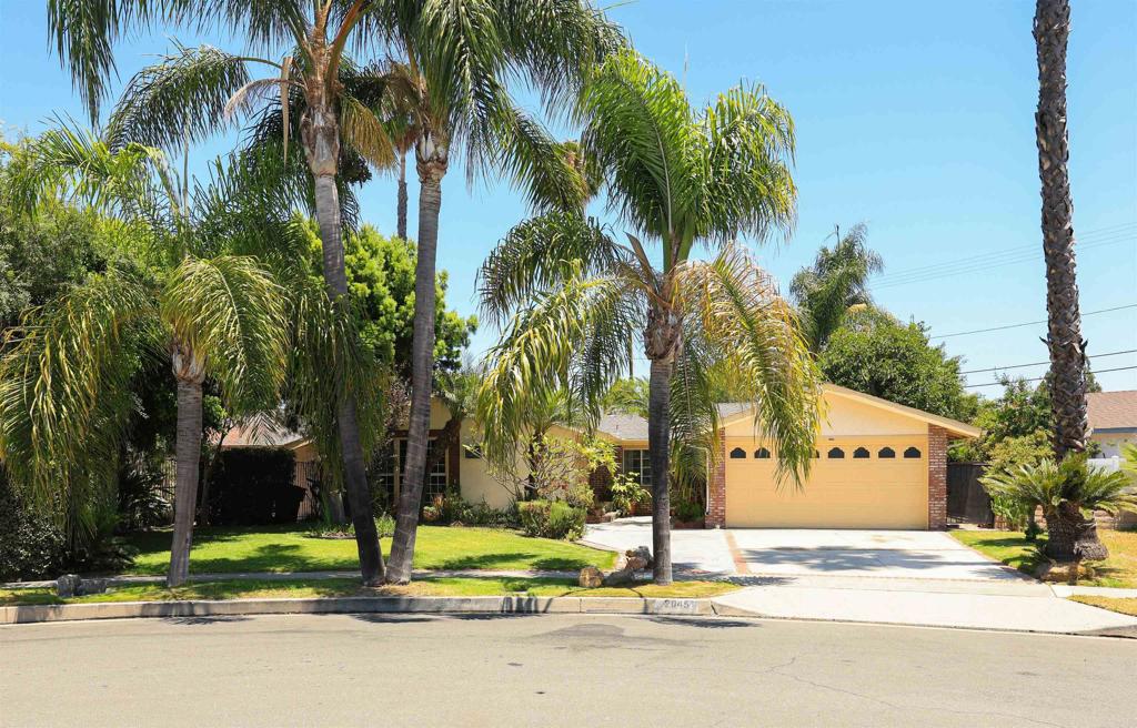 Entertaining Offers Between $999,900 and $1,069,900. Welcome To This Rare and Exciting Opportunity To Own A True Classic In One of Anaheim’s Most Established Neighborhoods! Built in 1954, this spacious single-story 4 bedroom, 3 bathroom home sits on an impressive 11,640 sq ft lot lined with swaying palm trees and bursting with character. Step inside and feel the warmth of mid-century design fused with timeless comfort. The inviting Living Room features vaulted ceilings and a cozy brick fireplace - perfect for relaxing evenings or entertaining guests. Just off the living room is the primary suite, complete with its own private bath, offering a peaceful retreat tucked away from the rest of the home. At the heart of the home lies the central Kitchen, ideally positioned for seamless flow between living spaces. Continue through to the expansive Family Room, which boasts a second fireplace and a spacious Dining Area - a fantastic setting for gatherings, game nights, or dinner parties. Step outside to your own private oasis. The covered back patio opens to a lush, expansive yard filled with mature trees, winding paths, and flourishing plant life—a tranquil escape for outdoor lovers, gardeners, and entertainers alike. Tucked at the back of the property is a detached bonus structure, perfect for a home office, art studio, workout room, or guest space—the possibilities are endless! With plenty of parking, a functional layout, and a lot size that offers both space and privacy, this home is ideal for almost anyone! Located near parks, shopping, schools, and just a short drive to Disneyland, this property offers the best of Anaheim living with room to grow, play, and personalize.