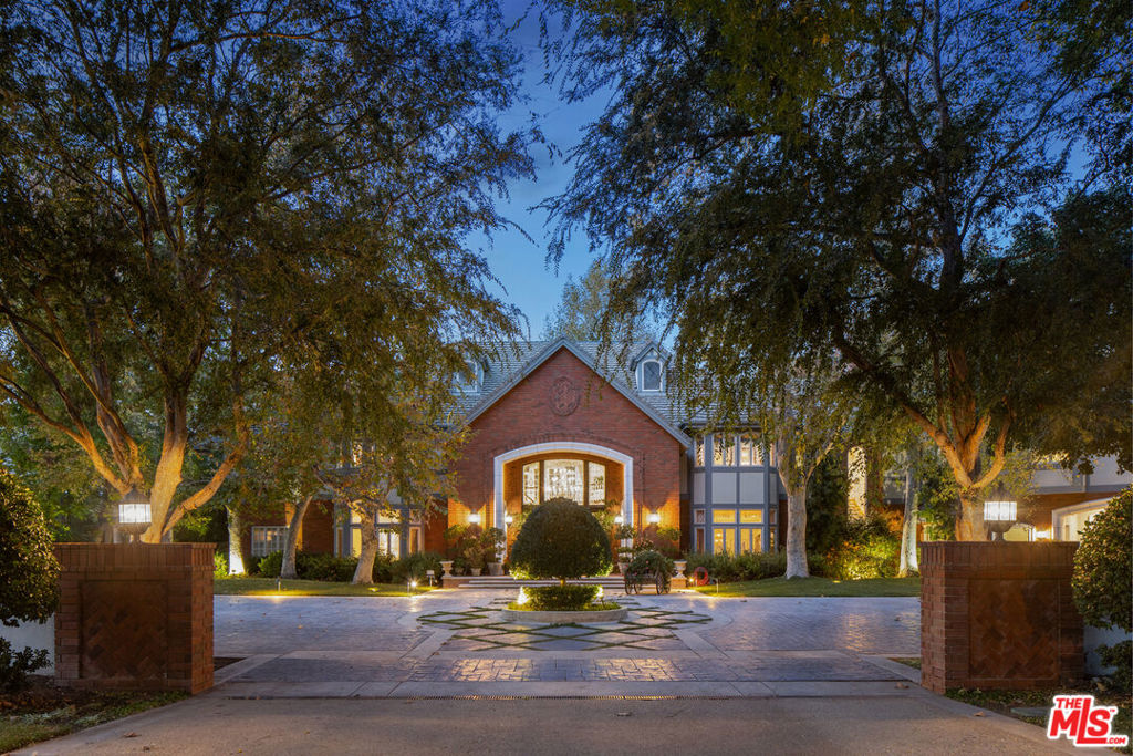 Welcome to the epitome of luxury living at this French Country Estate, a majestic property offering unparalleled elegance and opulence. This sprawling estate boasts 6 bedrooms and 11 bathrooms, providing a haven of comfort and style. As you approach, a picturesque tree-lined canopy drive guides you to a cobblestone motor court, surrounded by the sweet fragrance of citrus. Enter through the formal foyer, and be greeted by a grand staircase and 30' foot ceilings adorned with beveled glass windows that bathe the space in natural light.The craftsmanship of this estate is evident in the custom dark woodwork that graces the formal parlor, great room, and a formal dining room capable of accommodating 22 guests. The media room, complete with billiard wing, custom built ice cream parlor, and a spectacular wood bar, open up to lush greenery. The chefs kitchen, equipped with high end appliances, including BBQ station, food warmers, walk-in pantry, and 2 sub-zero refrigerators/freezers. The sun-filled breakfast room is surrounded by french doors which lead to park-like resort grounds.The master suite is a private retreat with a spacious sitting room, gym, his and hers walk-in closets, a five star resort spa with steam shower & sauna. A veranda overlooks the meticulously landscaped backyard. Additional features include, executive office, hobby room, 5 family bedrooms, a large laundry room, 6 fireplaces + 1500 square feet of storage space and an elevator.The indoor/outdoor flow continues to an outdoor paradise, featuring a lighted tennis court, a large rock themed pool and spa with beach entry, built in covered BBQ and dining area + bar with outdoor seating. Separate pool house/cabana complete with indoor jacuzzi, warming fireplace, changing room and bath. The large grassy play area completes the grand scale entertaining oasis. Porte cochere leads to ample parking area and 8 car garage, workshop space, and generously sized barn. Entire estate is surrounded by 12 acres of lush groves with 1600 Valencia Orange trees and 180 grapefruit trees all meticulously maintained. A separate 3BR/2BA ranchers casita w/ private entry and 2 car garage. A Smart system allows control of gated entry, multi-zone A/C, security cameras, sprinklers and indoor/outdoor custom lighting from your mobile phone. Located 10 minutes to Camarillo Metro, yet with all the benefits of elegant country living at its finest!