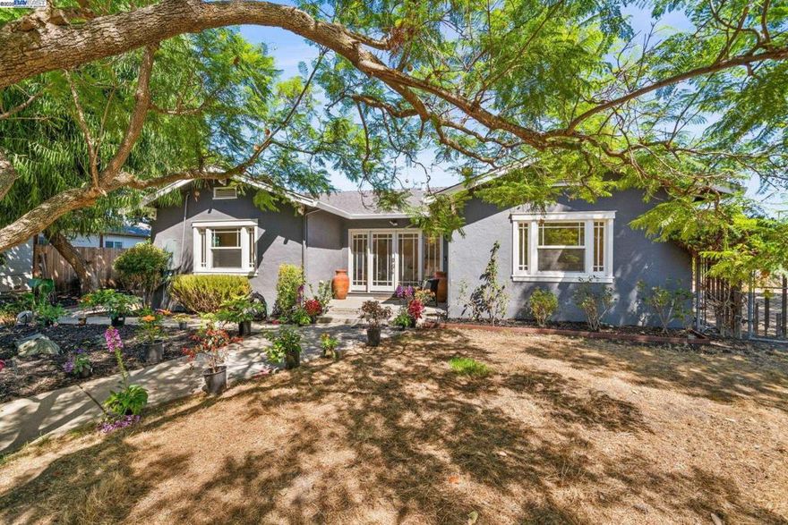 Huge lot, private end location, and unmatched serenity. Live in this updated home, expand it, or build your dream estate—the possibilities are endless. Situated in Mission Valley, this property boasts a 1,664 sq ft house with an additional 2 bed, 1 bath, 1,000+ sq ft ADU on an expansive 17,000 sq ft lot across two separate parcels. Inside, the spacious open-concept living room flows seamlessly into the formal dining area and remodeled kitchen. The kitchen showcases quartz countertops, modern cabinetry, stainless steel appliances, and pantry storage. The primary suite features generous closet space and a sliding door that opens to the park-like backyard. Its updated bath includes a double vanity, sleek fixtures, extra linen cabinets, and laminate flooring. Additional highlights include dual-pane windows, fresh interior paint, luxury vinyl flooring, remodeled baths, central heat & A/C and an enclosed patio with laundry area. Outside, enjoy a large gated driveway and a detached 2-bedroom, 1-bath ADU with its own private patio. Nestled on a lilac-lined street along the creek, this home is close to award-winning schools, Ohlone College, Mission Peak, and Central Park, with easy access to I-680. Open house Sat. 10/11 from 1:30-4:00 pm.