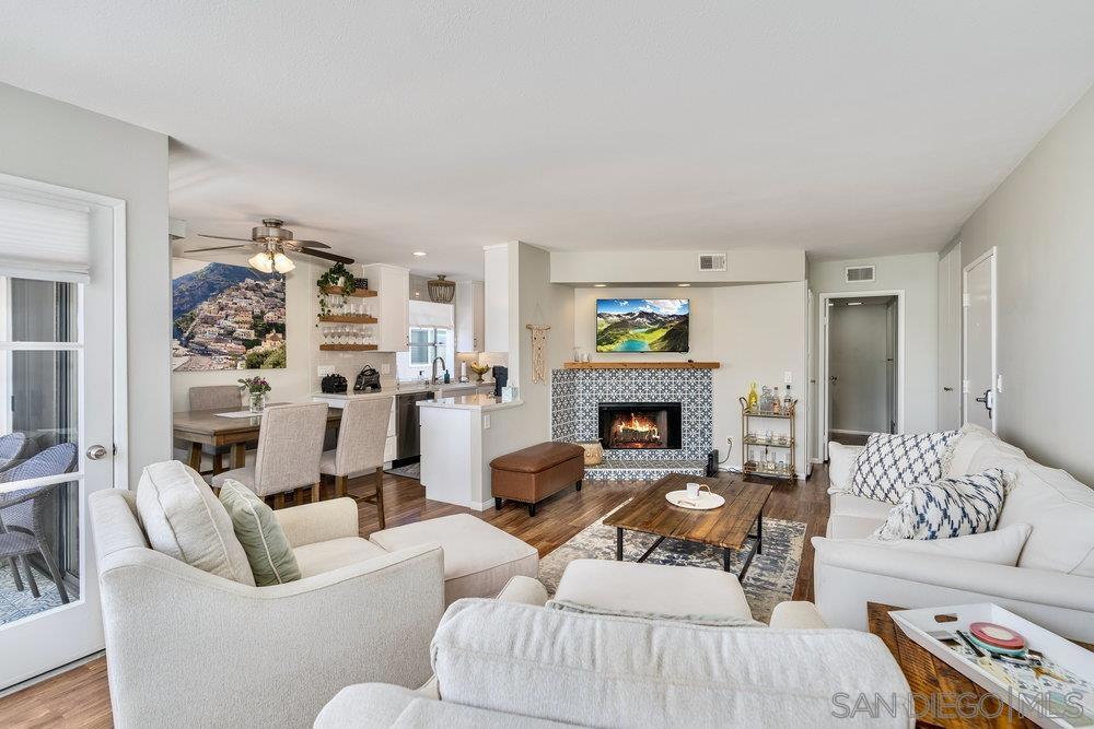 Discover your perfect coastal retreat—a top-floor sanctuary in a beautifully maintained community, ideally located just minutes from Sunset Cliffs, Ocean Beach, Downtown, and Mission Bay. Natural light pours through large windows, highlighting the open living space designed for comfort and style. Imagine cozy evenings by the fireplace, morning coffee on your private balcony with ocean-kissed air, and effortless weekends exploring Liberty Station or strolling the sand. The kitchen is appointed with a gas range, microwave, dishwasher, and newer refrigerator—ready for everything from casual meals to festive gatherings. A full-size washer and dryer are conveniently located inside the home, making everyday living simple. Both bedrooms are generously sized. The primary suite provides a restful retreat, while the second bedroom offers flexibility for guests, a home office, or fitness space. With a BRAND-NEW ROOF already installed, this home is move-in ready. The community offers lush landscaping, two sparkling pools, a relaxing spa, and covered parking. HOA dues cover water and trash, adding ease to ownership. Whether you’re looking for a full-time residence, a coastal escape, or an investment property, this home is an exceptional opportunity to own a piece of San Diego’s coveted lifestyle—effortless, inviting, and ideally located.