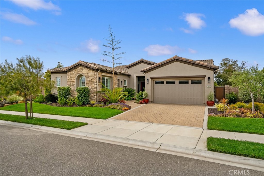 Sleek. Modern. Expansive. Welcome to the Carmel, one of the most highly-sought-after models, offering the space and luxury you deserve. Built in 2017, at 2991 sq. ft., this beautiful modern home features 3 bedrooms, 4 bathrooms, a sunroom and a Casita with private entrance. What makes this floor plan so popular is the flexibility of the main living spaces - a living room, family room and formal dining room surround the kitchen with infinite possibilities how the space is used. This particular Carmel has been highly customized with stunning engineered hardwood floors throughout, custom light fixtures, Plantation shutters (where needed) - the family room features a media/art display wall, the back patio has been completely enclosed to create a unique sunroom, and the entire property has been professionally designed with hardscape and landscaping to bring it to its full potential. Starting in the all-white kitchen of your dreams, you’ll love the top-of-the-line GE Monogram appliances including a built-in refrigerator, 6-burner gas cooktop and double wall ovens, beverage fridge, gorgeous white quartz countertops, raised panel white cabinets (many of the uppers are lighted with display glass), glossy glass tile backsplash, a large quartz island and a substantial walk-in pantry. Entertaining is a breeze - relax in the sunroom or continue outside to the custom waterfall wall with hand painted tiles and fire pit, or meander the garden paths to large sitting areas on both sides of the massive yard. Back inside, your owner’s suite awaits with a spacious bedroom and an all-white luxury spa bathroom with dual sinks, large shower with dual shower heads and seamless glass enclosure, separate Roman tub, vanity, linen storage and a fully outfitted walk-in closet with mirrored door. The guest wing features a bedroom with en-suite all-white bathroom and a self-contained Casita with private entrance, living room, bedroom and all-white spa bathroom with sink, vanity, quartz countertops and tile shower with seamless glass enclosure. Additionally, there’s a powder room, SmartSpace/laundry with built-in work station, solar, and a 2-car garage with EV charging plug. This gorgeous home, located in Trilogy Monarch Dunes, will not last long. Call us today!