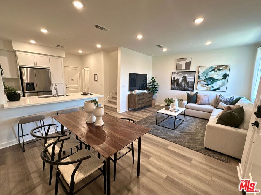 This town home is the epitome of style, practical design, and energy efficiency in a bright and open layout. Best of all, there is NO MELLO-ROOS in this new construction community-- very rare to find! Every space is thoughtfully finished with durable materials and sleek details that stand the test of time. The kitchen features white shaker-style cabinets, a full 3x12 white tile backsplash, and white sand quartz countertops for a clean, elegant look. Stainless steel appliances, including a refrigerator, dishwasher and microwave, are all included to make moving in effortless. Throughout the home, luxury vinyl plank flooring extends across the living areas and bedrooms, complemented by tile in the bathrooms and laundry room. With no carpet anywhere, this design offers a cohesive aesthetic that's easy to maintain. The spacious laundry room includes a side-by-side washer and dryer and generous storage space. The primary suite is flooded with lots of natural light and is a true retreat. The secondary bedrooms can also function as a home office, or guest bedroom. Energy-saving features such as a tankless water heater, QuietCool whole-house ventilation system, and solar panels (available for lease or purchase) support both comfort and sustainability. Life at The Grove extends beyond your front door. The community offers an inviting outdoor gathering area complete with picnic tables, a covered seating space, and two built-in BBQ's ideal for get-togethers with family and friends. A green astro-turf area provides space to relax, while pet stations placed throughout the community ensure convenience for residents with pets. Located in a prime area of West Covina, The Grove places you near local shops, dining, and recreation offering a well-rounded lifestyle in a setting designed for easy living. Virtual tour and some photography are of former model home and used for representational purposes only.