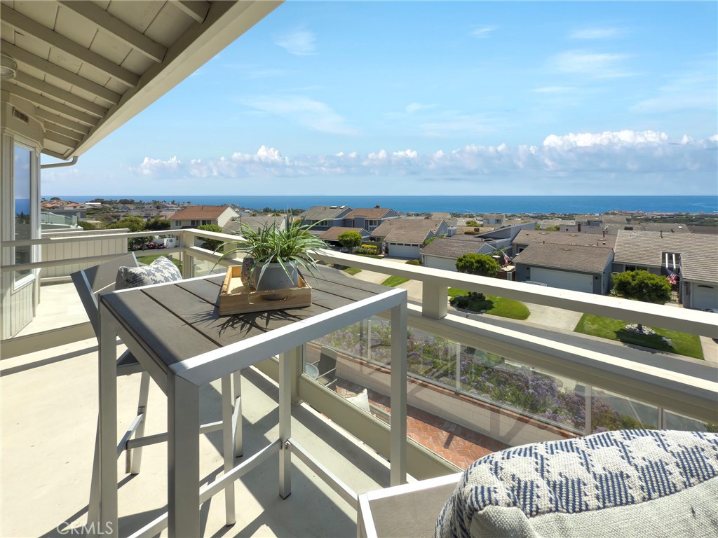 BEACH BARGAIN...BEST VALUE ALONG THE COAST...Located in the 24-hour gated oceanfront community of Niguel Shores situated next to the Ritz Carlton Hotel and very near to the Waldorf-Astoria Monarch Beach Resort and the Links Golf Course, this expanded and remodeled 3 Bedroom and 2.5 Bath, plus open den/office, 2-story Townhome features a panoramic ocean and Catalina Island view plus nightlight views of coastal hills all the way to Palos Verdes. The property includes hardwood flooring, recessed lighting, new French Doors to patio, spacious living room and dining room plus a bonus room area off of entry. The Chef's kitchen includes a commercial style gas stove and built-in stainless steel appliances, granite counters and custom cabinetry. The primary suite boasts a spectacular ocean view, walk-in closet, new dual sink vanity and large expanded shower. The second bedroom highlights an amazing ocean view and opens to a deck. All baths have been updated including an expanded powder room. The bricked backyard patio spotlights the lovely ocean and sunset views perfect for entertaining while the front entry includes a gated courtyard. The property features a finished 2-car garage with built-in laundry sink and work area plus cabinetry and a long driveway. This property is on a premium single-loaded cul-de-sac street with nearby trails to Club and to the Beach. This superb community includes a blufftop oceanfront park and parking lot plus a Clubhouse with pool, spa, pickleball, tennis, sports courts, play area and more. Enjoy the fun coastal lifestyle all year around living in Niguel Shores...The "BEST-KEPT" Secret Along The Coast! The Marina at Dana Point and Village of Laguna Beach are just minutes away.