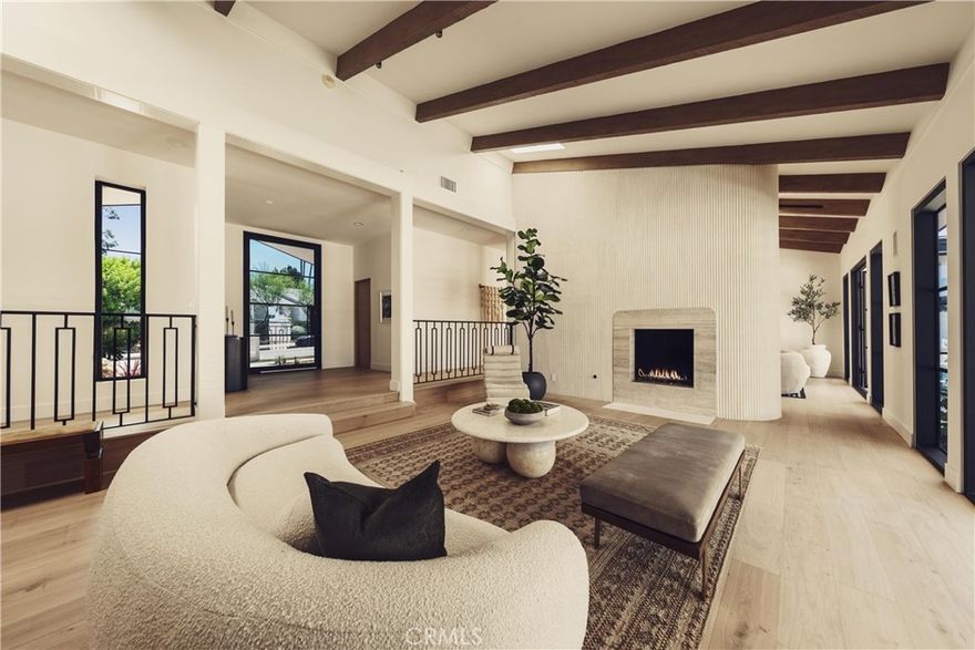 Welcome to this stunning, sprawling residence in the Hills of Encino, offering timeless, luxurious design and exceptional craftsmanship. From the moment you arrive, the smooth stucco façade with limestone accents delivers striking curb appeal. Travertine steps lead you to an impressive ten-foot glass entry door, setting the tone for what awaits inside. The foyer is bathed in natural light, thanks to multiple iron French doors and strategically placed skylights. The great room is anchored by an expansive fluted architectural fireplace, creating a sophisticated, inviting ambiance. Throughout the home, premium finishes, including French oak engineered hardwood flooring. A massive living room faces the backyard seamlessly flows into the chef’s kitchen, highlighted by a large island with fluted wood paneling, abundant white oak cabinetry, top-of-the-line Thermador appliances, and a walk-in pantry for added convenience. Adjacent to the kitchen, a private family room offers a cozy retreat separate from the main entertaining areas. A central hallway leads to two bedrooms, a formal dining room featuring a built-in wine rack, a stylish bathroom, and a utility room with laundry facilities. In the southern wing, you’ll find two en-suite bedrooms and the expansive primary suite overlooking the backyard. The primary bathroom is a showstopper, with dual showers featuring travertine checkered floors, limestone flooring, and a custom dual vanity topped with Arabescato Corchia marble. The custom walk-in closet provides generous storage and organization. The low-maintenance backyard is perfect for entertaining, with travertine flooring throughout, a large pool and spa, built-in barbecue, and integrated speakers. An additional spacious side yard features a pergola-covered patio with peek-a-boo views. For added convenience, there is an additional bathroom with access from the side yard for those using the pool. This home offers a luxurious, timeless aesthetic sure to impress, all within close proximity to the best shopping and dining the Valley has to offer.
Seller is open to credit buyer towards rate buy down with the right price.