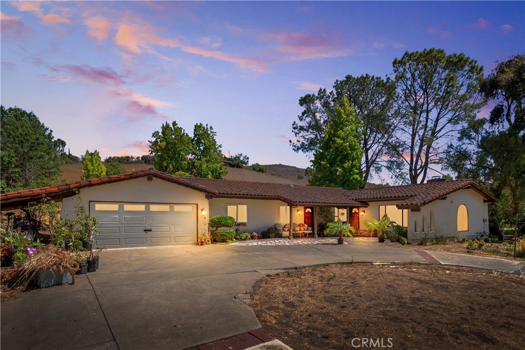 Rarely available, this ranch-style retreat is nestled on nearly five, mostly flat and usable acres in the heart of the Santa Ynez Valley, offering endless opportunities.
A circular driveway leads to the single level four bedroom two bathroom residence which spans approximately 2,800 square feet and features a stucco exterior with a clay tile roof, an attached two car garage, timeless Saltillo tile flooring throughout, and a cozy fireplace that anchors the living space with warmth and character.
The property is enhanced by multiple outbuildings including a three car garage, a pole barn and workshop, providing flexibility for equestrian facilities, agricultural ventures, or creative workspaces. With its level terrain framed by sweeping mountain views, the land is exceptionally versatile and well suited for a range of uses whether envisioned as a private ranch estate, an agricultural investment, or a commercial ranch hybrid.
Positioned directly along Highway 246, the property combines exceptional visibility with everyday convenience, located in the Buellton school district and just minutes from shops, and community amenities, making this a rare and compelling offering with both lifestyle and investment appeal.
