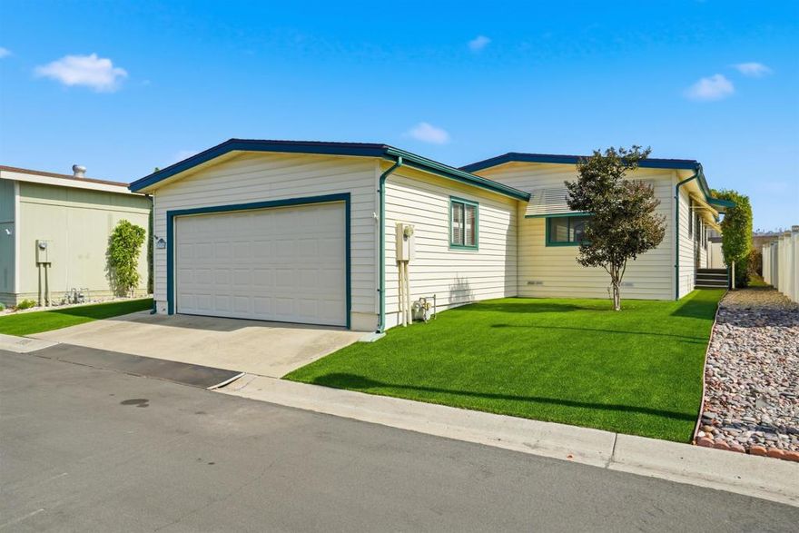 Well maintained light and airy home with central AC in the New Frontier gated community!  This sought after +55 community has it all with it's lush greenbelts, walking paths and friendly neighbors.  It has 2 relaxing pools, 2 indoor hot tubs, tennis courts, pickle ball, horseshoes, a putting green, game room, community room, library, and more. This single level home has a great layout featuring 2 nice sized bedrooms with new carpet, 2 full bathrooms, a large kitchen with lots of counter and cabinet space, a separate dining room, a laundry room and a huge living room too.  The master bedroom has double patio doors that open up onto a covered patio area.  Many of the homes in New Frontier do not have yards and garages but this home has both!  It's front yard has low maintenance artificial green turf and it also has a fully fenced backyard with a covered patio for your BBQ's.  It also has a large 2 car garage with lots of space for storage and tools.  There is 1 parking spot in front of the garage and nearby guest parking as well.  This complex even has space for your RV to be stored and a car wash!