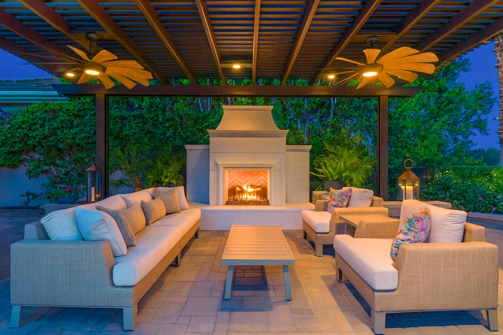 An entertainer's paradise, this exquisite residence showcases a recently completed indoor/outdoor transformation. Located on the 2nd fairway of the Greg Norman Course at PGA West, this popular four-bedroom Ventana plan is renowned for its open-concept design, which seamlessly connects indoor and outdoor living spaces.  The resort-style backyard features a louvered pergola-covered kitchen island with a Lynx BBQ, Lynx pizza oven, cocktail/wine station, a warmer drawer, and plenty of storage. Enjoy evenings by the large freestanding fireplace under the louvered pergola, or sit by the separate fire pit.  Unwind in the pool and spa framed by cascading waterfalls and dramatic fire pots.  Lush, professionally designed landscaping surrounds the property, with a wrought-iron fenced yard offering both privacy and a view of the beautiful Santa Rosa Mountains. Inside, a just-completed kitchen remodel shines with an oversized quartzite island, newly added cabinets, matching quartzite counters, and backsplash. Special features include subzero refrigerator, a Miele dishwasher, a Viking Professional cooktop and oven, a warming drawer, a new sink and faucet, and a built-in wine cabinet.  The laundry room has just been remodeled to create more space and convenience, including new quartzite counters, newly added cabinetry, a new washer and dryer, a new sink, and a faucet. The primary suite offers spa-like luxury, and a detached casita provides guest privacy. Newly furnished main living areas, kitchen, bar, and family room with exquisite Restoration Hardware furnishings and Restoration Hardware chandeliers and wall sconces. From the beautifully appointed interiors to the resort-inspired backyard, this residence offers a lifestyle to be celebrated, not just lived.