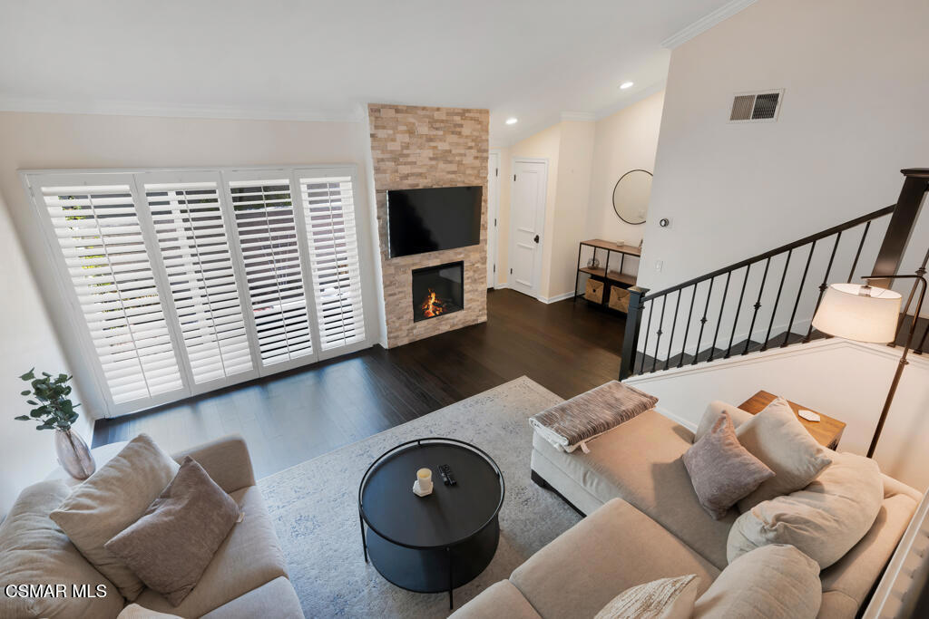 Welcome to 6217 1/2 Nita Ave.! - a beautifully upgraded 3-bedroom, 3-bathroom townhome offering 1,518 sq ft of stylish, move-in ready living space in highly desirable Woodland Hills. Step into the light and bright floorplan featuring wide plank bamboo flooring, recessed lighting, crown molding and dual-pane windows with elegant plantation shutters throughout. The inviting living room showcases a stunning stacked limestone fireplace and sliding glass doors that open to a private brick patio--perfect for relaxing or entertaining. Enjoy the fully renovated kitchen boasting crisp white cabinetry, granite countertops, stainless steel appliances and a convenient breakfast bar/built-in desk area. Upstairs, the generous primary suite offers a walk-in closet, charming window seat and ensuite bathroom complete with quartz countertops, a dedicated vanity area, marble-accented tile and sleek frameless glass shower doors. Two additional well-sized bedrooms, two beautifully updated full guest bathrooms as well as a direct-access two-car garage with laundry hook-ups complete the home. This gorgeous, turnkey property combines modern upgrades with timeless charm--don't miss your chance to make it yours!