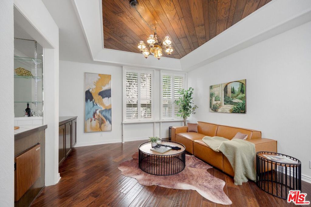 Located within the highly sought-after Encino Plaza North complex, this beautifully appointed condo offers the perfect blend of privacy, comfort, and convenience. This light-filled residence spans two spacious bedrooms and two bathrooms, across a generous floor plan designed for both relaxed living and effortless entertaining. The inviting kitchen boasts ample counter and cabinet space and opens up to a charming family room with a wood-paneled ceiling. An expansive living room with a cozy fireplace seamlessly connects to the formal dining area, complete with a wet bar and direct access to a tranquil private patio perfect for indoor-outdoor gatherings. The luxurious primary suite features its own fireplace, dual walk-in closets, and an abundance of additional storage tucked behind a mirrored sliding door. The en-suite bathroom offers a dual vanity, ample built-ins, a soaking tub, and a separate step-in shower. The secondary bedroom also includes a walk-in closet and easy access to the hall bathroom. Additional highlights include an in-unit laundry room with a washer and dryer, two dedicated side-by-side parking spaces, and a private storage unit. Enjoy a host of resort-style amenities such as two sparkling pools and spas, a fully equipped gym, and a recreation room. Just moments from shops and dining along Ventura Boulevard including the vibrant Encino Town Center. Welcome home!