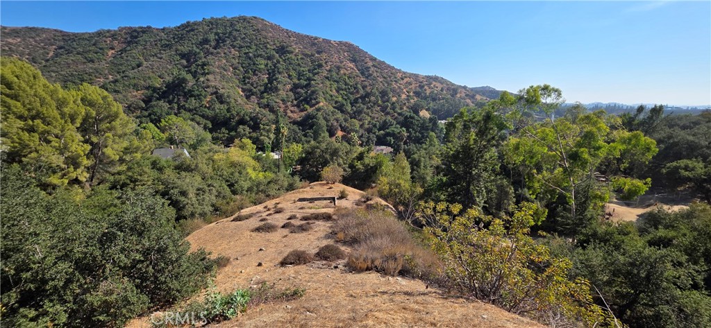 Imagine waking up every morning to the serene beauty of mature trees, rolling hills, and the peaceful ambiance of nature. Nestled in the heart of the highly sought-after Chevy Chase Canyon, this exceptional lot offers sweeping, panoramic mountain views that are nothing short of breathtaking. Surrounded by multi-million-dollar estates, this prime land presents the perfect opportunity to design a custom residence that marries luxury with the natural world. The property enjoys easy access to nearby canyon trails, inviting you to explore the lush landscape that defines this coveted enclave. With two parcels included in this listing, the potential is endless. Whether you envision a sprawling estate or a more intimate retreat, this lot offers endless possibilities. The neighborhood is home to top-rated schools, scenic golf courses, boutique shopping, renowned dining, and easy access to major freeways - making it an ideal balance of seclusion and convenience. This is a rare opportunity to secure a spot in one of Glendale's most prestigious locations, where you can create the home of your dreams in a community of unparalleled beauty.