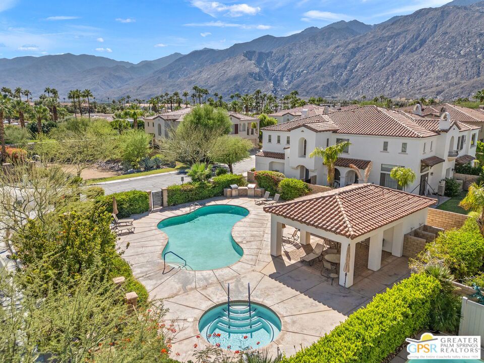 Fabulous Palm Springs pied--terre! In a prime midtown location behind the gates at Terra Vita, this home puts you just moments from downtown while offering a relaxing community setting. The living area is anchored by a stacked stone fireplace and enhanced by modern recessed lighting, while the open-concept kitchen features Caesarstone countertops, counter seating, custom tile flooring, and a spacious pantry. Light and bright throughout, the home includes baths with walk-in showers, and the ensuite primary retreat offers dual vanities and a beautifully tiled shower. Step out to your private balcony, accessible from both the dining area and the primary bedroom, to take in those iconic south-facing mountain views. Additional highlights include generous closet space, a separate laundry room with built-ins, and a direct access two car. Terra Vita is an intimate 42 home community with a resort style pool, spa, and poolside cabana with barbecues, and HOA fees are refreshingly reasonable compared to many others. Stylish, low maintenance, and close to it all, this home is perfect for seasonal use or full time living and welcomes you to your Palm Springs escape.