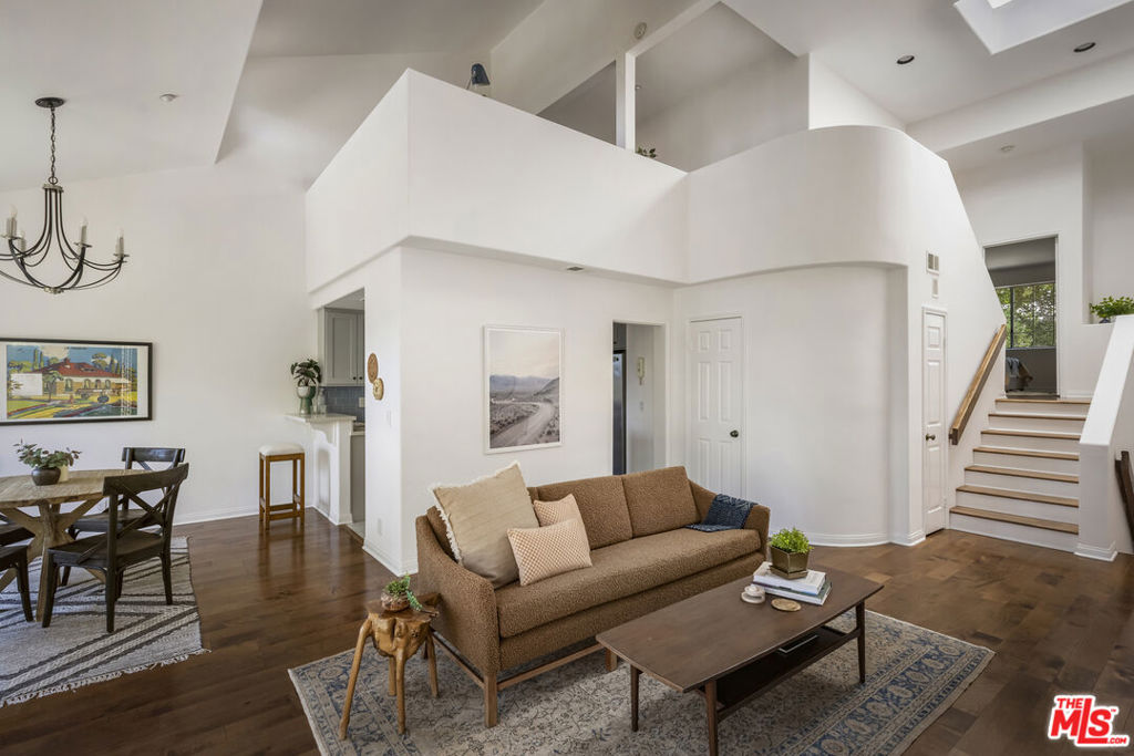 This charming light-filled Mediterranean townhome is located mere steps from many of the charming shops and boutiques stores in the quaint village of Sierra Madre. The exclusive gated enclave offers a quiet lifestyle while surrounded by the picturesque San Gabriel Mountains. Offering 4 levels of living space, this free-flowing floor plan features 3 bedrooms, 3 bathrooms, a loft, and an attached two-car garage. Upon entering you discover the grand two-story fireplace, arched passageways, dramatic 20-foot ceiling, and a crowning skylight that floods the interior with natural light. Work or unwind in style from the top floor loft while overlooking the expansive living space below. Occupying an entire level, the primary suite showcases vaulted ceilings, an enormous dressing area, dual vanities and a large soaking tub. Descending to the main level, you'll be greeting by the formal living and dining spaces that leads to a private balcony which captures mountain views. The recently remodeled kitchen provides modern convenience and easy flow for entertaining friends and family. The lower level has two spacious and quiet bedrooms that share a large guest bathroom. The sizeable garage on the lowest level provides ample parking and storage. As one of the closest residential properties to downtown, this townhouse puts amenities at your doorstep. Just minutes to excellent schools, the 210 freeway, Pasadena, Santa Anita Park, Huntington Gardens, and a wide array of hiking trails.