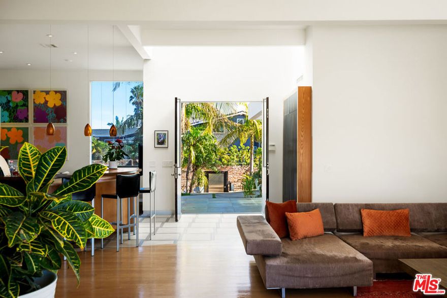 This Pacific Palisades custom-built luxury home in the beautiful Marquez Knolls neighborhood is available for short-term and long-term rent to qualified applicants. The modern architectural home comes fully furnished, including custom-made Italian couches, bedframes, dining tables, chairs, and coffee tables. Built in 2007, the home is in excellent condition with hardwood and stone floors throughout and carpet in the bedrooms. Nearly every room offers beautiful ocean and mountain views, including the living room, master bedroom, and junior master bedroom. The master bedroom features a fireplace, heated floors, a jacuzzi tub, and a steam shower. The kitchen is equipped with modern appliances, including a Sub-Zero refrigerator, WOLF stove, and built-in Miele coffee/espresso machine. The property includes a two-car garage and a large gated driveway that can accommodate three additional vehicles. The large backyard has two levels: the main level includes a full BBQ and bar area with seating for entertaining while enjoying the ocean and mountain views, and the lower level features a wooden loggia with a firepit and built-in seating, ideal for watching the sunset. Fruit trees line the backyard staircase, adding to the charm of this exceptional home.