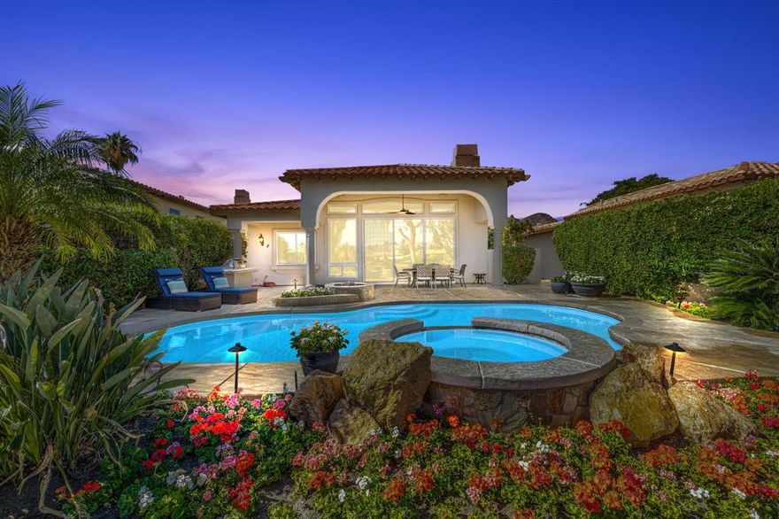 Welcome to your desert sanctuary in the prestigious Rancho La Quinta Country Club. This sophisticated 3-bedroom, 4-bath residence is perfectly positioned along the 13th and 14th holes of the Robert Trent Jones Jr. Championship Golf Course, capturing sweeping views of the fairways, a peaceful lake, and the majestic Santa Rosa Mountains. Designed for refined desert living, the open-concept floor plan blends elegance with comfort. The spacious great room features a custom built-in entertainment center and expansive picture windows framing the stunning views. The gourmet kitchen seamlessly connects to the living and dining areas, ideal for both everyday enjoyment and entertaining guests. The luxurious primary suite serves as a private retreat, complete with a spa-inspired bath featuring dual vanities with generous counter space, a large soaking tub, separate glass-enclosed shower, and a massive walk-in closet. Each guest suite includes its own ensuite bath, offering privacy and comfort for friends and family alike. While a separate den makes for a great home office, work out space etc! Outdoors, the beautifully designed rear yard is an entertainer's dream--complete with a custom outdoor kitchen, built-in firepit, and an expansive stamped concrete patio ideal for dining al fresco or relaxing while taking in the panoramic golf course and mountain vistas. Additional highlights include a two-car garage plus separate golf cart garage, providing ample space and storage and fresh paint throughout the interior! As a resident of Rancho La Quinta, you'll enjoy world-class amenities including two championship golf courses, tennis and pickleball courts, a state-of-the-art fitness center, fine dining, and a vibrant social community--all within a secure, guard-gated setting surrounded by the beauty of the desert landscape.