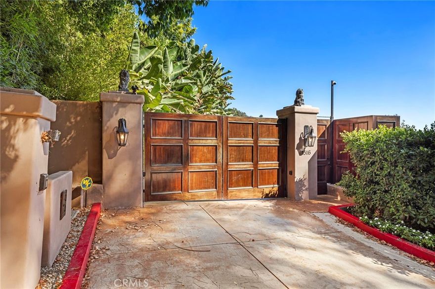 Great value and priced for IMMEDIATE occupancy! Impressive private gate leads you to this Mediterranean VIEW Estate on a quiet cul-de-sac. 5 bedrooms with desirable and hard to find PRIMARY BEDROOM ON THE MAIN LEVEL!, 8 bathrooms, 3 fireplaces, pool/spa and city light view. Gourmet granite kitchen features Viking appliances, large island and walk-in pantry. Very bright with 17 sets of French doors and soaring 9 1/2 foot and 10 foot ceilings. Wood and stone flooring throughout. The spacious primary bedroom has a large walk-in closet with custom built-ins, fireplace, and French doors leading to a large balcony. The lower level has a HUGE great room plus three and a half baths. All three downstairs bedrooms have their own full baths with access to balconies. The rear yard overlooks treetops and city light views, outdoor bar, pool/spa, and full bathroom. The side yard has a lawn area, two fountains, cozy fireplace and seating area. Property is directly across the street from the new LeBron James Estate. Perfect floor plan for multi-generation family! Can be offered furnished for $35k/mo with one month deposit. Will consider shorter term furnished or unfurnished...call agent for price and terms.