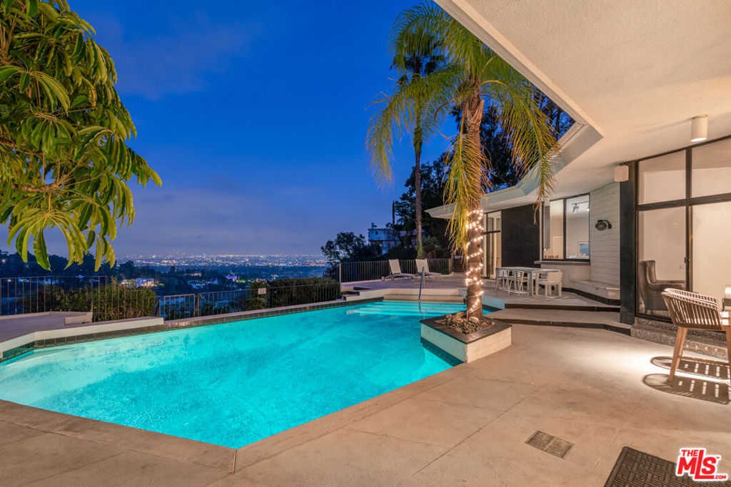 Sited on a breathtaking view promontory in prime Lower Bel Air, this view estate sited on nearly 2 acres is one of the best development or fixer opportunities in Los Angeles surrounded by $30M-$295M homes. Once the home of famed singer, Tom Jones, this Mid-Century modern home features grand scale and walls of glass that showcase unobstructed city and canyon views from almost every room. Designed by celebrated architect William R. Stephenson, this architectural masterpiece is privately sited behind gates and features a large motorcourt, 4 Beds & 6 Baths, an open floorplan featuring an incredible indoor-outdoor flow, sparkling pool, and large, contiguous patio perfect for entertaining. All bedroom suites are expansive, and the primary suite boasts a viewing deck, wet bar, fireplace, walk-in closet, and massive windows that showcase stunning canyon and city views. The sheer acreage and buildable pad provide endless opportunities to potentially redevelop this property to include an impressive residence featuring 18,000SF+/- of interior living space. This is a once in a lifetime opportunity to build a legendary new construction tour-de-force, or simply remodel the existing home featuring great bones amongst multimillion dollar estates such as it's direct neighbor, "The One."