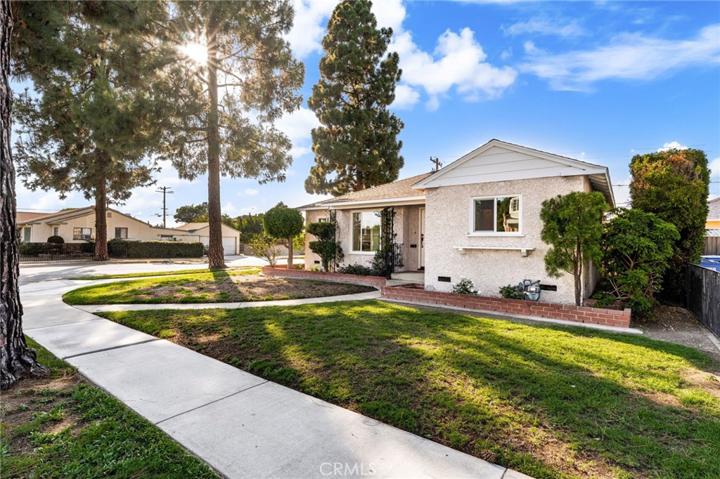 This sprawling 1950-built beauty may just steal your heart!
Lovingly owned and impeccably maintained by a single family for 75 years, this is your chance to own something truly special.
Thoughtful upgrades abound with brand-new dual-pane vinyl windows throughout, stunning luxury vinyl plank flooring in the kitchen and family room, and plush new carpeting flowing through the living room, hallway, and all bedrooms. The entire interior has been freshly painted in crisp white, with new door hardware, updated bathroom sinks and faucets, and newly stained solid oak cabinetry gracing the kitchen and both bathrooms. At the heart of the home is a warm, inviting kitchen featuring an abundance of space, plus a walk-in pantry, built-in china cabinet, and an expansive countertop spanning the length of the room. Appliances include Double ovens, dishwasher and refrigerator. The kitchen sink is bathed in light from a cheerful window which allows for pleasant breezes and sweet neighborhood views. All of this plus plenty of room to gather around your table make this the place you'll want to linger. The family room features a handsome raised hearth wood-burning fireplace as well as ample space for gatherings and lively fun. For quieter moments, the formal dining and living rooms offer a touch of elegance, complete with a lovely window framing peaceful views of the neighborhood. The front portion of the home features three cozy bedrooms, ample closets and a full bath, plus the formal living and dining room. Steps past the kitchen is the inviting family room, the laundry room, another full bath and two larger bedrooms. The laundry room is spacious with an abundance of cabinetry and storage and a nearly new washer and dryer that will stay with the home! Steps away, a pedestrian door offers access to the rear patio which makes for a lovely open air retreat. The back portion of the yard offers fruit trees, grape vines and private access to the two car garage.
Situated on a generous corner lot, this home provides excellent parking and the awesomeness of two separate entrances — the perfect setup for multi-generational living or even the potential to divide the home into two separate units. Located in a welcoming neighborhood and close to shopping, dining, parks, and great schools...Be ready to fall in love!