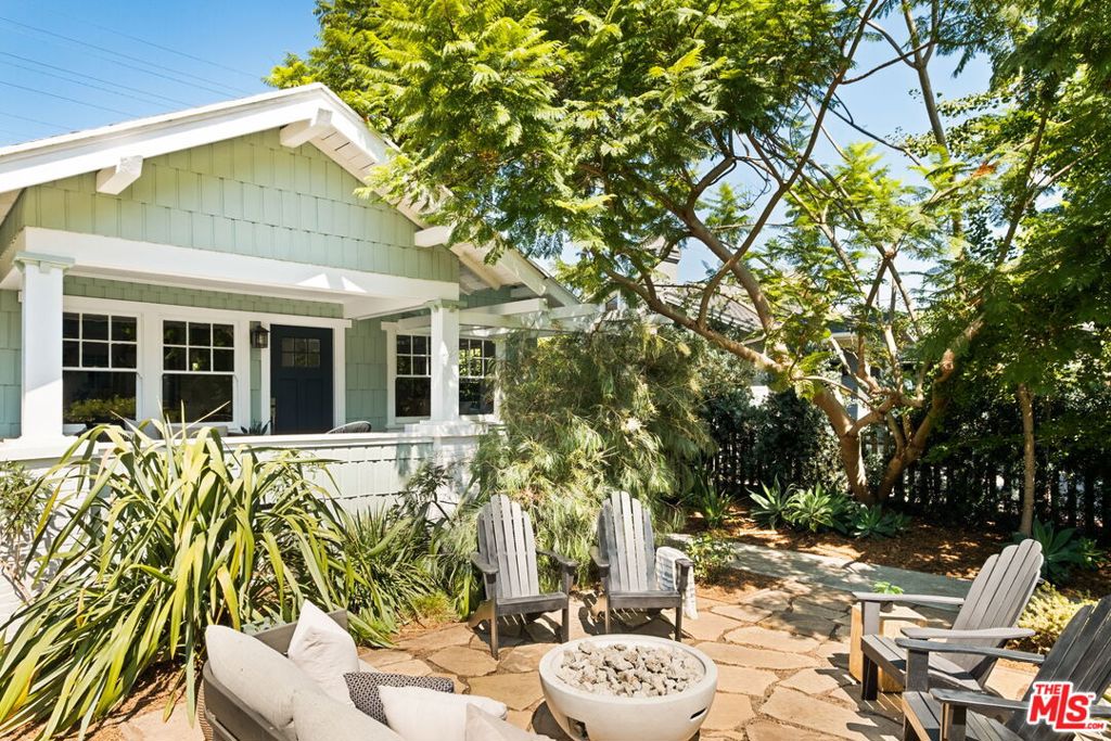 Dreamy Venice bungalow set in the heart of the historic Walk Streets. This storybook home welcomes you with an inviting front porch, perfect for lazy morning coffee and breezy coastal evenings. Enter an airy and sun-filled living room w/beautiful hardwood floors, vintage details and large picture windows, offering garden views. The living room opens to a formal dining rm w/ built-in buffet. There's a sparkling modern kitchen with a farmhouse sink and new stainless appliances. Two freshly updated baths, central air with Nest thermostats, and a tankless water heater add comfort and convenience to the home's historic soul. Relax & dine al fresco in the peaceful backyard, enjoy the company of hummingbirds and butterflies, amidst the gentle ocean breeze. A detached studio with French doors and high wood beam ceilings offers flexibility, with multiple uses as a home office, gym, or guest room. Perfect walk street location on beloved Marco Place, neighboring wonderful bungalows & architectural modern homes. It's remarkable that such serenity is moments away from the boutiques, world-class restaurants & energy of Abbot Kinney. Also close by are Erewhon, Superba Cafe and the bike path to Venice Beach.