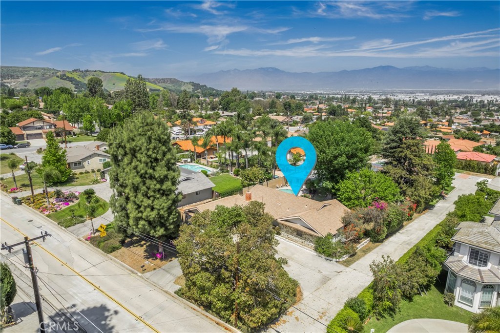 Turnbull Canyon Pool Retreat with Permitted Bonus Space. This charming single-story home in the highly sought-after Turnbull Canyon neighborhood sits on a nearly half-acre flat lot surrounded by million-dollar estates. Fresh paint and laminate flooring flow throughout the interior. Step inside to a formal living room with skylights and recessed lighting. The step-down formal dining room features French doors that open to the backyard. The spacious family room includes a cozy fireplace, opens to the kitchen, and has a convenient three-quarter bathroom nearby. Outside, the fully fenced and gated backyard includes a sparkling pool and a large grassy yard. A permitted 546 square foot detached pool house provides versatile space for guests, a home office or gym. There is also room to build or expand on the expansive flat lot. The home also offers a laundry area inside and direct access to the attached two-car garage. This property offers an excellent opportunity to live in one of Hacienda Heights’ most desirable neighborhoods.