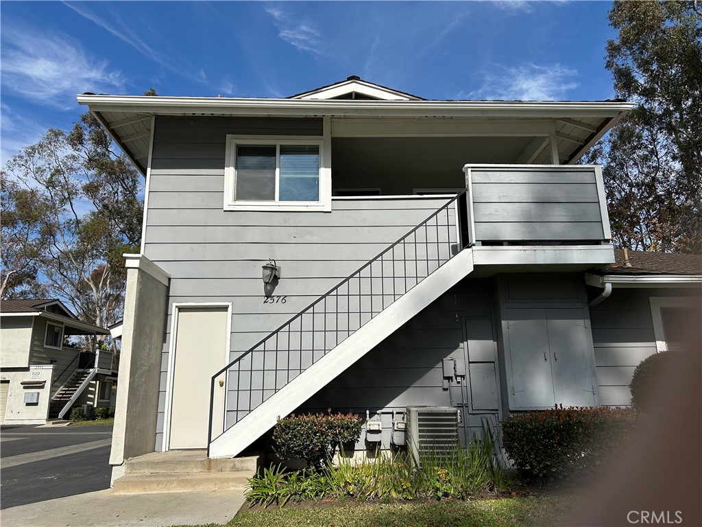 This unfurnished, cozy end-unit (attached only on one side with no one above or below) upper level entrance provides added privacy with a covered porch, featuring 2 bedrooms and 1 bathroom. This single-level unit with double pane windows offers bright and airy living room which is open to the dining area. Updated kitchen with quartz countertops and stainless steel appliances. Walk down the hall through the double doors to find spacious master bedroom with Walk In Closet. Convenient 2-car garage below in addition to plenty of guest/street parking. Take advantage of all the wonderful amenities: association pool/spa, sports court and a playground for children in a park-like setting. Surrounded by single family residences and conveniently located near hiking/biking trails, Los Coyotes Golf Course, Clark Regional Park. Award famous winning schools: Sunset Lane Elementary, Parks Junior High and open enrollment for Sunny Hills High School.