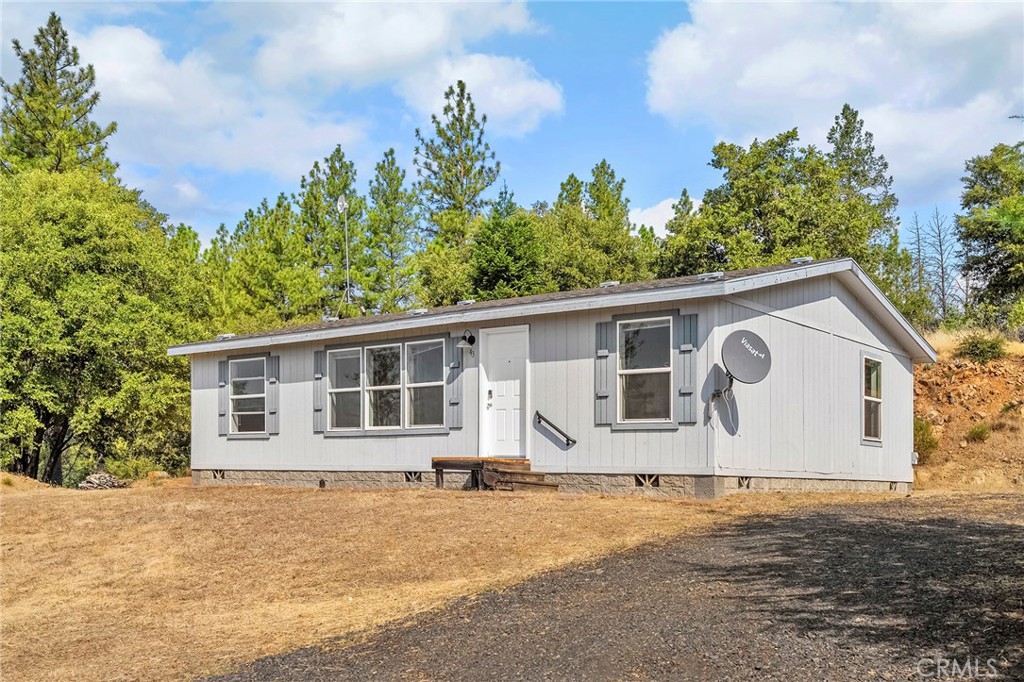 Enjoy peaceful mountain living on just under 6 acres, with wide-open views and room to grow. This well-kept 3 bed, 2 bath home offers privacy and functionality just minutes from Lake Oroville with a split floor plan. Features include a whole-house generator, RV parking with full hook-ups, and plenty of usable land—ready for a shop, garage, or garden. Tucked away at the end of a quiet road, this property blends seclusion with convenience, only 25 minutes to town. Outdoor recreation is right nearby, with Lake Oroville offering boating, fishing, hiking, and weekends on the water.