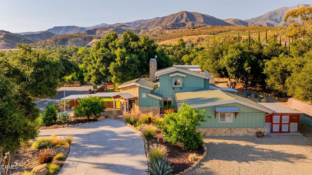 Welcome to your private Ojai retreat. Set beneath the majestic Topa Topa Mountains, this nearly two-acre Ojai compound offers an extraordinary blend of privacy, luxury, and thoughtful design.Situated amongst mature trees and tasteful landscaping, the main residence is warm and inviting boasting 4 bedrooms, 3 bedrooms, stone and wood details, generous windows, and mountain views throughout.A separate two-bedroom, two-bath guest house offers privacy and flexibility--perfect for hosting visitors or for use as an income-generating rental. At the heart of the property, a striking 2,400-square-foot open-air barn invites entertaining on any scale, from intimate gatherings to grand celebrations.Additional features include a 900 sq ft workshop with full lighting and electrical, a 150 sq ft secondary workshop, and two spacious storage sheds (160 & 200 sq ft). A deluxe dog run with artificial turf completes this exceptional estate, offering comfort and convenience for your four-legged companions.The resort-style backyard features a sparkling pool and spa set among native boulders, multiple al fresco dining areas, a custom fire pit, a full outdoor kitchen with BBQ/smoker and wraparound bar--perfect for effortless, year-round entertaining.Whether enjoying coffee on the private upstairs balcony or lounging by the pool, every element of this property evokes the relaxed, soulful charm of Ojai.This rare Ojai real estate offering is a retreat like no other, surrounded by nature yet minutes from town. Don't miss the opportunity to own a home that invites you to slow down, settle in, and savor the essence of Ojai.