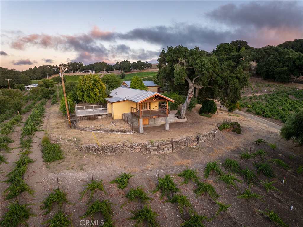 For over 100 years, this Westside Templeton estate has played a role in California wine history. First planted in 1924 by Amadeo Martinelli in a traditional Italian style, the 6.06 acre vineyard remains in production today—organically farmed Zinfandel, head-trained, and still thriving on original stock. Set on 9.6± acres in the desirable Templeton Gap District of Paso Robles AVA, the property offers generous space to build a primary residence and continue a celebrated story of winemaking. Permits are in place to produce wine onsite, and all fruit is currently contracted with Turley Wine Cellars (yields range from 4.47 to 12.56 tons in recent years). Limited ownership financing potentially available. The original 1934 winery, fifth to be bonded post-prohibition, stands alongside a newly added ADA compliant bathroom and separate meeting room. Today's winery is now the cellar under a 1920s cottage, partially updated with a new roof, windows, plumbing, and a spacious deck with breathtaking views. While a bathroom and additional interior updates are needed, the space offers excellent potential for restoration. Architectural plans included. All that, plus a permitted manufactured home with separate entrance and workshop. Historic fruit trees dot the landscape from Bing cherry, apricot, and pomegranate to orange, lemon, and peach. Opportunities abound. In a region of bold winemakers, this is your chance to define a legacy all your own.