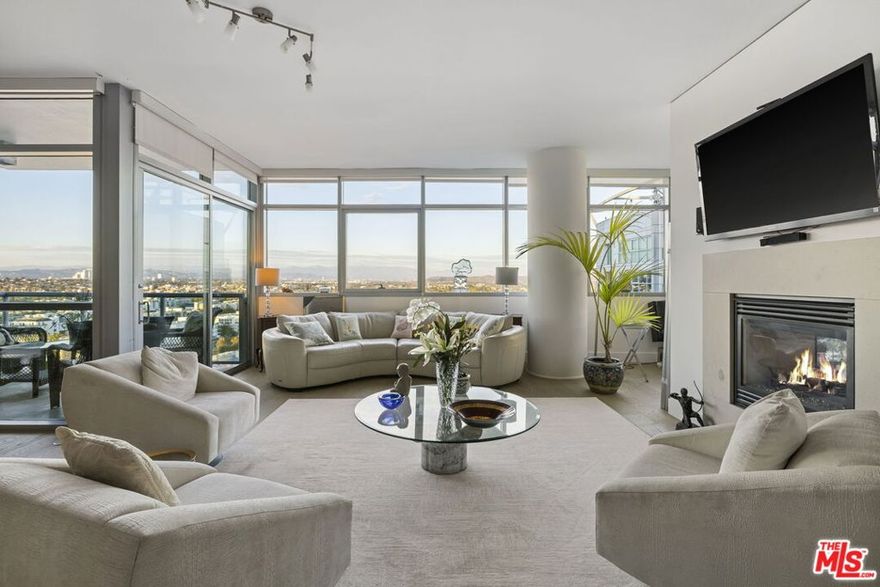 Welcome to a stunning 18th-floor, newly remodeled junior penthouse in The Cove, Marina del Rey's premier full-service high-rise. This spectacular residence features 2 bedrooms + den/office, 2.5 baths, and approx. 2,349 sq ft of luxurious living space. Soaring 10-foot ceilings, open layout, and dual balconies capture expansive, unobstructed city lights and mountain views.  Enter through Elegant double entry doors into a grand living area with beautiful new oak hardwood flooring and a cozy fireplace.  The gourmet kitchen is wonderful for entertaining. Beautiful, oversized center Island features Quartz countertops, Waterfall feature, all-new stainless steel appliances, a double oven, a wine refrigerator, and Studio Becker cabinetry. The primary suite is a true retreat, with an oversized walk-in closet, dual sinks, a marble countertop, a generous soaking tub, and a separate shower.  This home offers turnkey luxury living.   Enjoy an array of first-class amenities. The Cove: 24-hour desk, valet parking (for residents and guests), gym, heated pool & spa, outdoor BBQ area, recreation lounge, library, conference room, guest suite, landscaped grounds, and controlled access.  The HOA dues include gas, water, cable, and earthquake insurance. This unit also comes with two rare side-by-side covered parking spaces. One of a kind, unique open floor plan with stunning views. Live in Luxury Must See....