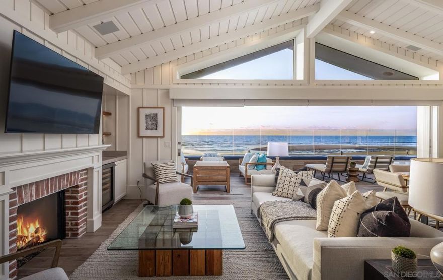 An extremely rare opportunity to own a corner-lot, oceanfront home directly on the sand in Del Mar, this 5-bedroom coastal retreat offers unmatched privacy, no direct neighbor to the north, and unobstructed panoramic views from every angle. A massive wraparound deck creates the ultimate setting for indoor-outdoor living with space to lounge, dine al fresco, soak in the jacuzzi at sunset, or rinse off in the outdoor shower after a surf session. Tastefullyrenovated with top-tier finishes and a timeless coastal design, this property blends casual beach living with elevated style. The single-level main residence features an ocean-view primary suite with vaulted ceilings, a guest suite, spacious open-concept living, and two full bathrooms. The detached guest quarters above the garage include two additional bedrooms, two bathrooms, and a cozy family room with wet bar, while a separate bedroom and bathroom with private entrance sits adjacent to the garage. Located just steps from Del Mar’s most popular restaurants and shops, this home checks every box for luxury beachfront living and is truly one of a kind.