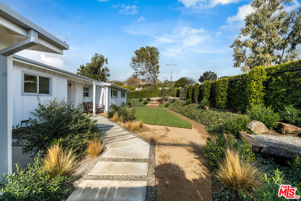 This beautifully redone one-story Contemporary Ranch home is located on one of the most quiet & tranquil cul-de-sacs in Malibu Park offering stunning ocean views and is set on over one acre of mostly usable land providing ample space for horses, a barn, a pool or plenty of space to build an ADU. The home features three bedrooms, including a spacious primary suite with ocean views and a large walk-in closet, two bathrooms, and a gym or home office. The open floor plan includes gorgeous hardwood floors throughout, a two sided fireplace that you can enjoy from both the living and dining rooms & fully approved plans and permits for a brand new deck off the backside of the house which allows apx. 1,100 sq ft of outdoor space perfect for enjoying the surrounding nature with views of Point Dume and Zuma Beach. The fully gated front yard boasts a lush lawn with beautiful landscaping, a big flat pad that sits just above the main house with views perfect for an Air Stream trailer offering a peaceful and private serene space great for a guest or older child to reside. The fabulous gourmet kitchen is expansive and equipped with professional appliances perfect for cooking & entertaining. The laundry room includes a sink and an abundance of cabinetry for linens and storage. Additional features include a brand new metal roof, a Generac back-up generator and convenient proximity to mountain bike, horse and hiking trails as well as Zuma Beach and Malibu High School. This property offers the ideal blend of privacy and comfort. Available fully furnished. Property is completely fenced both front and back to keep your animals safe, 2 car garage with a great size driveway which provides ample parking.
