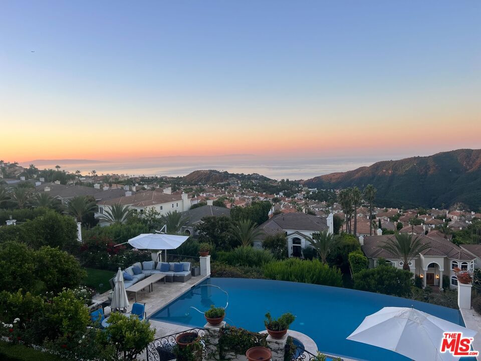 Welcome to 16864 Calle Bellevista in the guard gated Enclave. This 26,572 sf land offering is arguably one of the best ocean view sites in the Palisades Highlands and sits at the end of a cul de sac with nearly every home on the street untouched by the recent fires. Phase 1 & 2 debris removal have been completed and the prior infinity pool and lower outdoor level with over $1,000,000 of site work appears to still be intact. The prior home was 5,461sf so with the current ordinance a new buyer could potentially build over 6k sf above grade. Owner has started working on plans by Roman James Design Build who is a world renowned architecture and design firm. This is an incredible opportunity for anyone looking to be part of the expedited rebuild process and not be surrounded by construction for years to come. The home is also part of the Summit Club which gives owners access to tennis courts & pickleball courts, gym, additional heated pools & spa, party rooms, and childrens playground.