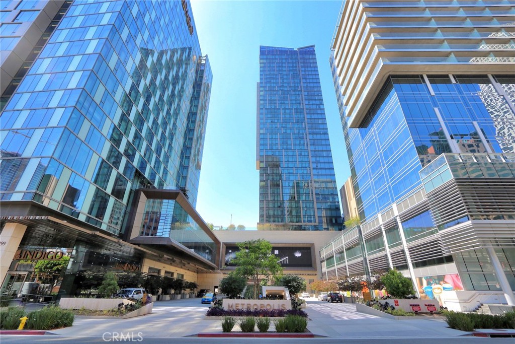 Experience elevated urban living in this sleek and spacious 1-bedroom, 1.5-bathroom condo in the prestigious Metropolis Tower 1. With wide open south-facing views, this high-rise residence showcases breathtaking vistas of the Downtown LA skyline, Griffith Observatory, and even the Hollywood Sign—visible from every room through expansive floor-to-ceiling windows that fill the space with natural light.
The thoughtfully designed interior features an open-concept layout with high-end finishes throughout, including Caesarstone countertops, custom cabinetry, premium Bosch appliances, and warm oak wood flooring that adds an elegant touch. In-unit laundry and custom window shades provide added comfort and convenience.
Residents of Metropolis enjoy exclusive access to resort-style amenities, including a sparkling pool and spa, fully equipped fitness center, steam room, private lounges, a screening room, and beautifully designed community spaces perfect for working remotely or entertaining. The building also offers 24-hour security, front desk service, and high-speed WiFi included.
Located in the heart of the Financial District, you're just minutes from Koreatown, Little Tokyo, and Crypto.com Arena, with the best of downtown dining, shopping, and entertainment right outside your door. Additional monthly parking is available across the street. This is modern city living at its finest—refined, connected, and effortlessly luxurious.