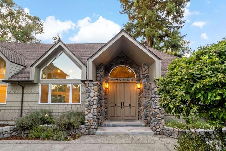 Tucked in the exclusive Edgewood Park neighborhood, this stunning estate greets you with a long private driveway, generous parking, and an impressive facade of high-peaked roofs, a three-car garage, and a welcoming formal entry. A charming detached cottage with its own backyard and private entrance offers exceptional versatility. Inside the main house, a grand office, soaring chapel-like ceiling living room, and a light-filled great room with oak floors and an open kitchen set the stage for elegant living. Walls of windows frame the lush backyard, while the classic staircase adds timeless character. The main level also features two oversized bedrooms, 1.5 baths, and a convenient laundry room that leads into garages. Upstairs, the primary suite boasts a fireplace, serene views, and a sprawling deck. A fourth bedroom large enough to serve as a family room completes the home. Minutes from downtown, 101, and 280, this is a rare blend of privacy, beauty, and convenience.