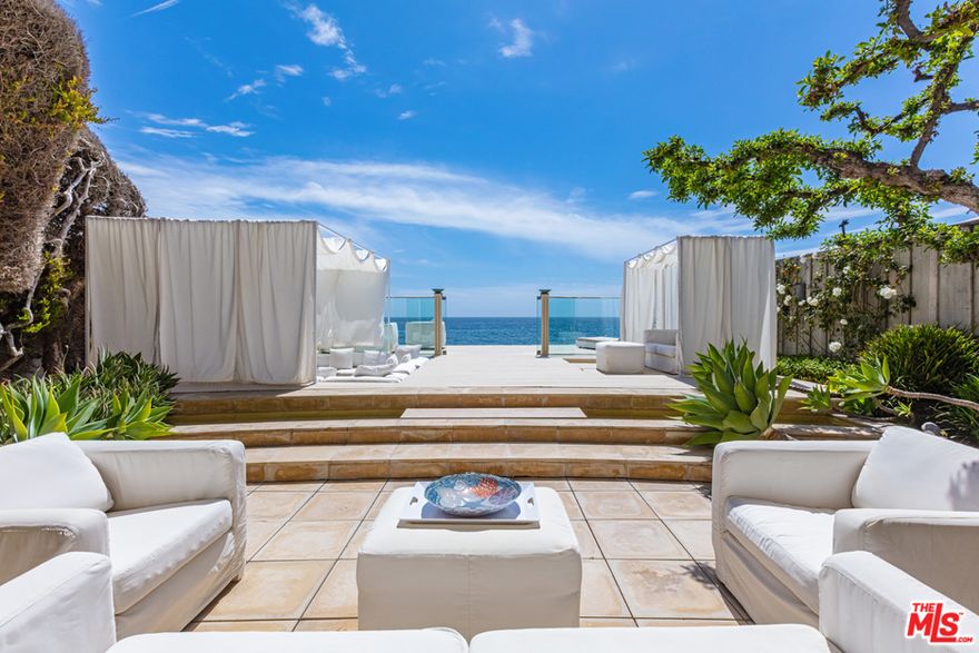 Welcome to La Luce della Luna ~ "The light of the moon". Behind the exclusive gates of Malibu Colony, this Italian villa captures the essence of classic design while fusing refined elegance with modern sophistication. Upon arrival, one immediately recognizes that this seaside residence is a one-of-a-kind offering. A fountain courtyard introduces the home, which features a luxurious living room with an arched mirror fireplace opening into an outdoor living area complete with a sunken fire pit and beachfront lounge, a ten-seat dining room, Romeo-and-Juliet French door balconies, and an intimate master suite retreat with spectacular whitewater and ocean vistas. The property also features three additional guest bedrooms, each spacious in size with ensuite bathrooms. The beautiful rooftop living environment is open and airy and includes an outdoor fireplace, a mini-kitchen w/ a refrigerator, and an outdoor television -- all with a backdrop of the incredible California coastline. Making life easy, the home features a state-of-the-art technology with an integrated, one-touch Control4 smart system, convenient for operating many of the home's features. This is a rare find and an incredible opportunity to make this breathtaking Colony dream home a reality.