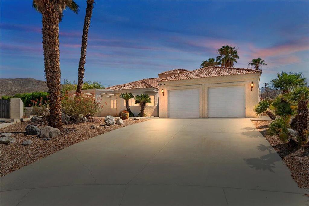 CUSTOM-HOME with amazing potential in the highly sought after Mission Lakes Country Club. Nestled in a cul-de-sac with PANORAMIC MOUNTAIN VIEWS this LARGE LOT boasts a front and back covered patio, a 4-car driveway, and a spacious backyard with INGROUND POOL AND SPA. Upon entering you are greeted by a front foyer with a high-ceiling and chandelier leading into an ENORMOUS GREAT-ROOM that incorporates the kitchen, dining area and living room with double-door entryways to the beautiful back patio. The living room is richly enhanced with a rock-wall fireplace, vaulted ceilings, and a GORGEOUS WET BAR with both a minifridge and wine cooler, glass door wall cabinets, and a long bar top. The massive u-shaped kitchen has a center-island with a built-in butcher block top, endless counter space, and an ABUNDANCE OF CABINET STORAGE...as does the living room and double-door walk-in closet that has been converted into a full office space. The IMPRESSIVE MASTER BEDROOM also has vaulted ceilings, a rock-wall fireplace, access door to the rear patio, in addition to an amazing master bath with dual sinks, soaking tub, and shower all adjacent to a GIANT WALK-IN CLOSET with mirrored doors. This fabulous home is further enhanced with SOLAR PANELS, indoor laundry room, and wide 2-car garage with rows of wall cabinets. ' PRICED TO SELL' for an over 2700 sq.ft., 3 bedroom/3bath floor plan on a big lot with a great location and breathtaking views. Mission Lakes Country Club HOA includes UNLIMITED GOLF for two owners on the semi-private 18-hole championship 'Ted Robinson' DESIGNER GOLF COURSE, an onsite pro shop, fitness center, tennis courts, a banquet room, fine dining, bar, the Sand Wedge Cafe, and a massive club pool and spa alongside the Mission Lakes Inn which accommodates club visitors and guests. Just minutes from downtown Palm Springs, the I-10 Freeway, and Coachella Valley's only International Airport this home is an INCREDIBLE OASIS OPPORTUNITY! Call Today to schedule a tour.