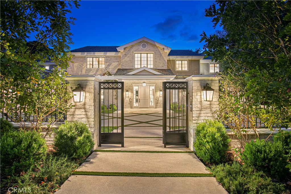 Nestled on a sprawling 31,685 sq ft lot in a prestigious south-of-the-boulevard Encino neighborhood, this grand estate masterfully combines traditional charm with contemporary luxury. A striking two-story entry welcomes you into an expansive dining room, leading to a sun-drenched kitchen and family room, all seamlessly flowing to a covered patio, pool, extensive lawns, sports court, and outdoor decks—ideal for both relaxation and entertaining. The main floor boasts a luxurious tiered screening room, a stately paneled library/executive office, a spacious guest bedroom, billiards room, butler’s pantry, powder room, and one of two convenient laundry rooms. Upstairs, the opulent primary suite features a private living room with a fireplace, a bedroom with cathedral-beamed ceilings, a generous terrace overlooking the grounds, a spa-like marble bath, and dual walk-in closets. Three additional grand en-suite bedrooms and an airy family room complete the upper level. A detached guest house offers a cozy living room, kitchenette, lavish bathroom, and a private bedroom—perfect for guests or staff. The expansive rear grounds are an entertainer's dream, with a BBQ and bar area, vast lawns, and a versatile sports court ideal for pickleball, basketball, roller skating, or large gatherings, all centered around a stunning pool and spa accented with arching fountains. The home is set back from the street, offering privacy and a double-gated circular drive with ample parking, including a cathedral-ceilinged 3-car garage with built-in storage. A separate, secured gate provides vehicle and catering access to the rear yard. With exquisite designer finishes, smart home technology, and impeccable craftsmanship throughout, this estate offers the highest level of luxury living.