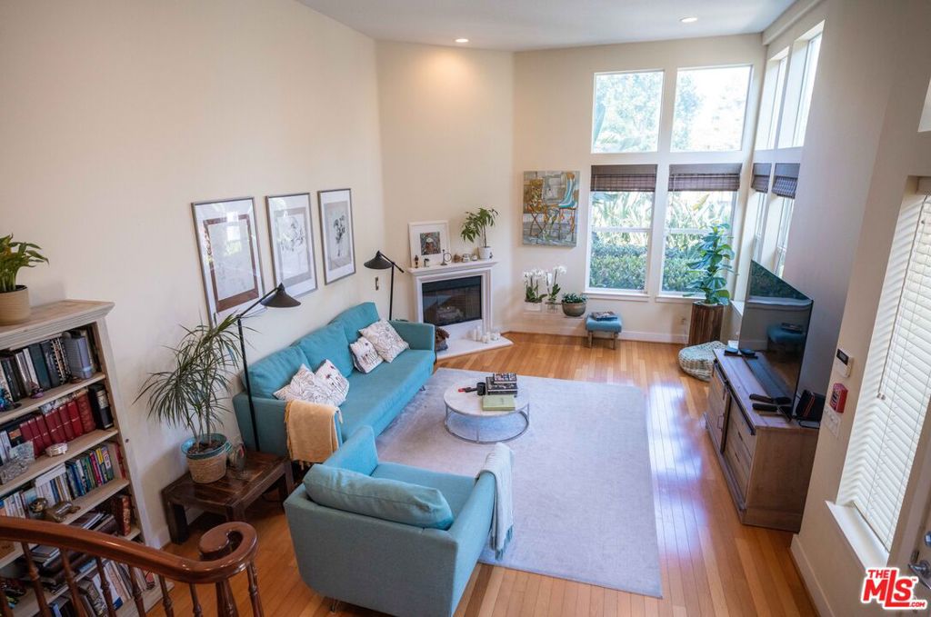 Welcome home to this artful retreat. Private and light filled corner townhome that feels like a single family home, complete with private garage. The configuration of this home fills it with natural light, green top views and privacy. Walk into a sun-drenched living room with wood floors and warm color palette on the walls. The heart of the home is the natural wood kitchen complete with granite countertops, stainless appliances, and a generous sized breakfast nook, along with french doors that open to a tranquil balcony. Take the light soaked stairs to the top level and enjoy the generous primary bedroom with treetop views, a fireplace, and its own balcony. Boasting a large walk in closet, high ceilings, and a spa-like primary bathroom with separate tub and large shower. On the same level is a junior bedroom with attached full bath. Lower level of townhome offers a bonus room, a separate laundry room, and a private garage. Huge crawl space/storage off the bonus room provides tons of storage space.