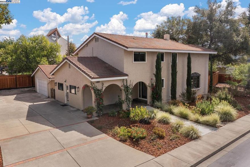 Exquisite Woodland Estates Retreat! Step into elegance with this rare single-family home, perfectly situated on a spacious 14,000+ sq ft lot with 1,600 sq ft of driveway space - in the prestigious, gated Woodland Estates. From the luxurious master suite, step onto your private second-story deck and enjoy peaceful sunrise views to the east and vibrant winter sunsets to the west. A newly built custom staircase leads to a beautifully landscaped backyard oasis—your own private park—ideal for entertaining or relaxing. This exceptional property also includes a remodeled in-law unit (ADU) with private entrance, full bath, closet, fridge, and cooking area—perfect for guests, extended family, or rental income. The main home features a sleek, modernized kitchen, spa-inspired master bath, custom walk-in closet, and refinished hardwood floors. Additional highlights include a new tile porch, expansive patio for indoor-outdoor living, new fencing with side and backyard access, and a drought-tolerant garden with edible plants. Enjoy the peace and security of this private gated community. Don’t miss your chance to own this unique retreat in Woodland Estates!