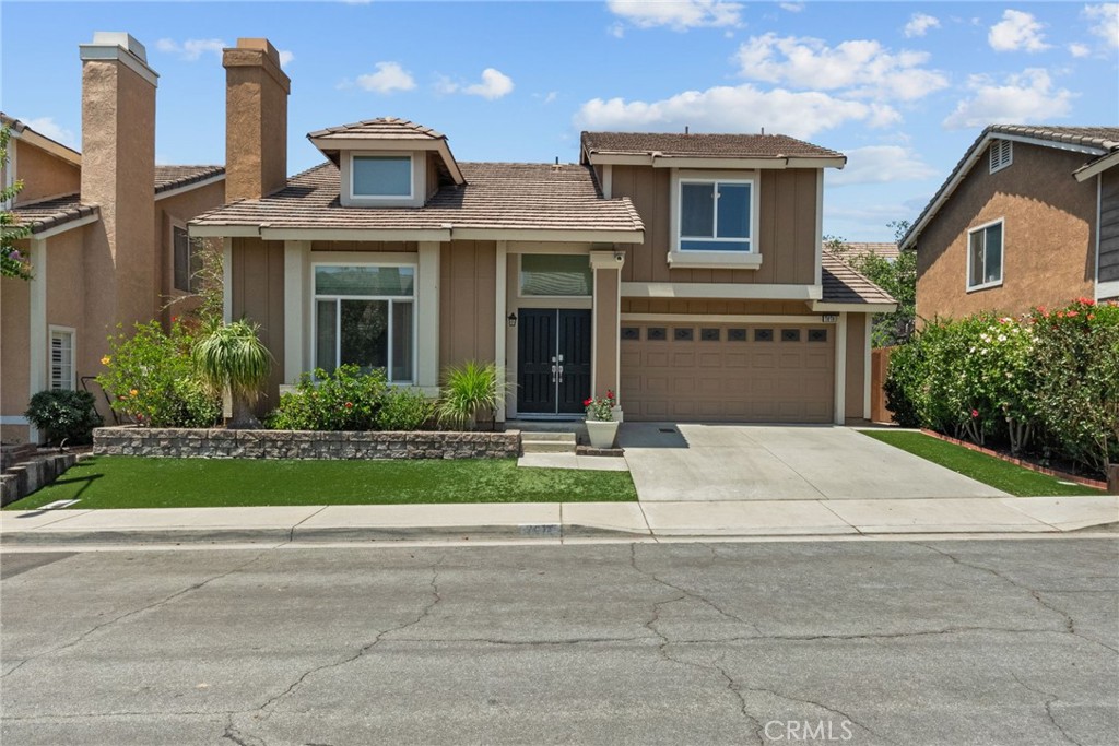 Welcome to a beautifully updated and thoughtfully upgraded home that blends classic elegance with modern convenience. From the moment you arrive, you’ll notice the pristine, low-maintenance front yard with premium synthetic turf—lush and green year-round, while saving you time and water. Step through the double-door entry into a light-filled living room with soaring ceilings and a striking fireplace feature wall that extends two stories high. Abundant windows and a skylight bathe the space in natural light, creating a warm and inviting ambiance. The remodeled kitchen showcases granite countertops, updated cabinetry, and stainless-steel appliances. A casual dining area flows seamlessly to the covered patio, ideal for indoor-outdoor entertaining. The backyard also features synthetic turf, ensuring year-round curb appeal with minimal upkeep. Downstairs, you’ll find a stylishly upgraded powder room with modern fixtures and tile, along with a cleverly added storage space under the staircase. The finished garage is a standout, featuring durable epoxy flooring, a newer water heater, a custom HVAC vent modification for pet comfort, and a recently upgraded electrical panel with EV charging capability. Upstairs are three generously sized bedrooms, all with ceiling fans for comfort. The hall bathroom has been refreshed with beautiful flooring, vanity, and fixtures. The spacious primary suite is a true retreat, offering vaulted ceilings, a walk-in closet, and an en-suite bathroom with dual sinks, a step-in shower, and elegant finishes throughout. Additional improvements include newer dual-pane windows and sliding doors, a modern HVAC system, and numerous smart updates that enhance both function and style. Situated just minutes from Victoria Gardens, award-winning schools, parks, and dog park, this home offers comfort, convenience, and a lifestyle you’ll love. Don’t miss your opportunity to own this turnkey gem—schedule your private showing today!