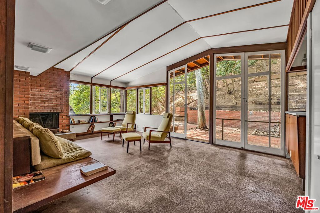 Available to market for the first time in 57 years, the Wertheimer House is a rare opportunity for architecture enthusiasts to preserve and restore an untouched piece of Los Angeles history. Documented by influential mid-century photographer Julius Shulman in 1962, this Beverly Glen canyon retreat articulates the major ideas of Southern California modernism: simplicity, economy, integrity and harmony with the natural environment. Built in 1959 by architect Lester Wertheimer, FAIA, as his own family residence and offered in its original condition, the home features two bedrooms that open onto a shared balcony, two bathrooms, an office (or possible third bedroom), as well as a private backyard patio nestled into the hillside and shaded by a canopy of mature oak and eucalyptus trees. Mid-century details include original custom built-ins and fixtures, three fireplaces, floor-to-ceiling glass doors, dynamic integration with nature, and an efficient two-story layout for harmonious living. Other amenities include off-street parking for two cars and easy access to UCLA, the Getty Center and Skirball Cultural Center, the Glen Centre as well as all the dining, shopping and services of Beverly Hills, Westwood, Ventura Boulevard and Brentwood. Nearby hiking trails and canyon roads connect you to the natural beauty of Stone Canyon Reservoir and the Santa Monica Mountains. The house is zoned for the coveted Roscomare Road Elementary School. With only two owners in its lifetime, the Wertheimer House seeks a new generation of stewardship to guide it into its next chapter.