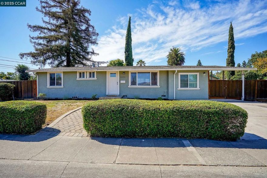Welcome to this beautifully refreshed 4-bedroom, 2-bathroom home located on a generous corner lot in the heart of Concord. Perfect for first-time buyers, multigenerational living, or savvy investors, this move-in ready property combines style, flexibility, and income potential. Inside, you'll find a light and bright layout featuring new flooring, fresh paint and updates throughout. The updated kitchen boasts contemporary cabinetry, and newer appliances—ideal for everyday living or entertaining. A standout feature is the converted garage, complete with its own kitchen and full bathroom, offering excellent potential as a private studio, guest suite, or rental unit (buyer to verify). The exterior offers even more possibilities, with a covered carport and roomy side yard—perfect for additional parking, a future ADU, or extra storage. The corner lot location adds privacy, space, and curb appeal. Centrally located near BART, freeway access, schools, and shopping, this home checks all the boxes for comfort, convenience, and opportunity.