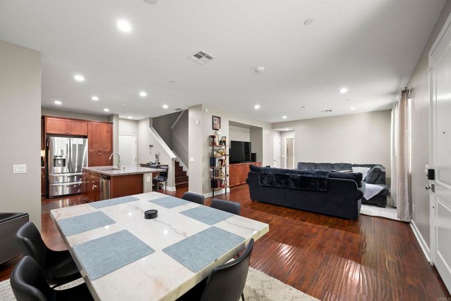 Beautifully Upgraded this energy-efficient 4-bedroom, 3-bathroom home includes a 2-car garage with an EV charger, making it ideal for modern Santee living located in the sought-after Mission Trails Collection community! SOLAR PAID. Enjoy a spacious open-concept floor plan featuring a sleek, contemporary kitchen with granite countertops, stainless steel appliances, and upgraded flooring throughout. The main level / downstairs includes a full bedroom and bathroom, perfect for guests or a home office. Upstairs offers two additional bedrooms, a full bath, and a convenient upstairs laundry room. The primary suite is a relaxing retreat with a custom walk-in closet and en-suite bathroom featuring dual vanities. This smart home includes a paid solar system, Nest Smart Thermostat, security system, and modern energy-saving features. Located near Mission Trails Regional Park, with quick access to major freeways, top-rated schools, shopping, dining, and everything Santee have to offer. Don’t miss your chance to own this eco-friendly, move-in ready Santee home in a prime location!