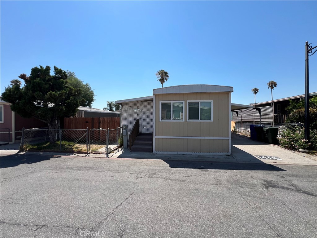 **** SPACE NUMBER IS ACTUALLY 140E AND IS POPULATING AS 101****
Discover your new home in the heart of central Fontana! This inviting 2-bedroom, 1-bath manufactured home is located in the desirable Sierra Village Park, offering a blend of comfort and convenience just minutes from the freeway.
Inside, you'll find a well-designed layout featuring a spacious kitchen that flows into a cozy dining area and a comfortable living room, perfect for relaxing or entertaining guests. Step outside to enjoy the large yard, complete with a generous covered front porch—ideal for sipping morning coffee or enjoying warm summer evenings. As part of a friendly community, residents can take advantage of the sparkling pool, perfect for cooling off during those sunny days. This home is ready to be sold ASAP, making it an excellent opportunity for new homeowners or investors. Don’t miss your chance to own this charming property—schedule a viewing today!