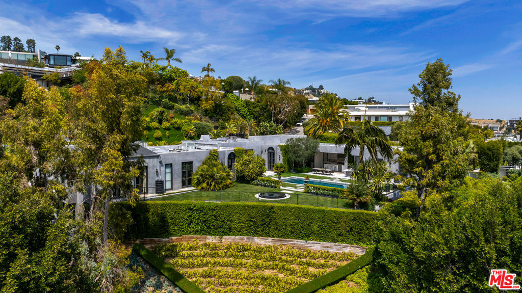 Redefining excellence, Welcome to 1457 Blue Jay Way. Situated on one of the largest flat lots on 'Billionaire's Row' in the Bird Streets, the Blue Jay Regency exhibits a coveted combination of land, location and luxurious living at its finest. The property was originally designed by famed architect Bob Ray Offenhauser, known for his use of perfect symmetry and scale. It is this concept of scale and proportion that anchor the unfolding vistas and coveted Hollywood Regency features in this residence. Award-winning designers, The Garratt Group, have faithfully restored and artfully extended the property with meticulous attention to every detail. The home boasts soaring 14 foot ceilings with custom finishes and the finest, state-of-the-art amenities that showcase the unique architectural style. The home features formal living/family room with Nanawall sliding glass doors to a gorgeous yard with views and unbelievable space. Formal dining with walk out to the yard and complete privacy from every direction! Property amenities include Chef's kitchen with double appliances and Calcutta gold marble counters, reformatted family room off the kitchen for lounging with soaring city views of DTLA, Lower level features a flex space (5th bdrm) with En suite, built-ins and separate entrance perfect for music studio, nanny room or guest room. Lower level west wing features gym/yoga studio space, wet bar with ~500 bottle wine cellar, professionally curated screening room/theater with 14 person capacity, and spa retreat with steam room, dry sauna and hot tub with jets. The home features an undeniably rare rooftop garden with over 80 fruit trees, 2 vegetable gardens, strawberry patch, passionfruit arbor herb garden and all underplanted with Rosemary and sophisticated irrigation system! You have never seen anything like this! Located just minutes from the Sunset Strip, enjoy the close by upscale restaurants and nightlife such as the Boa Steakhouse, Bird Streets Club, Soho House, Pendry & Edition Hotel, Sunset Tower Bar and the city of Beverly Hills just moments away. This ultra rare property comes with all of the greatest modern living features and aesthetics a home of this caliber has to offer! Don't miss this incredible property offering, you have not seen anything like this!